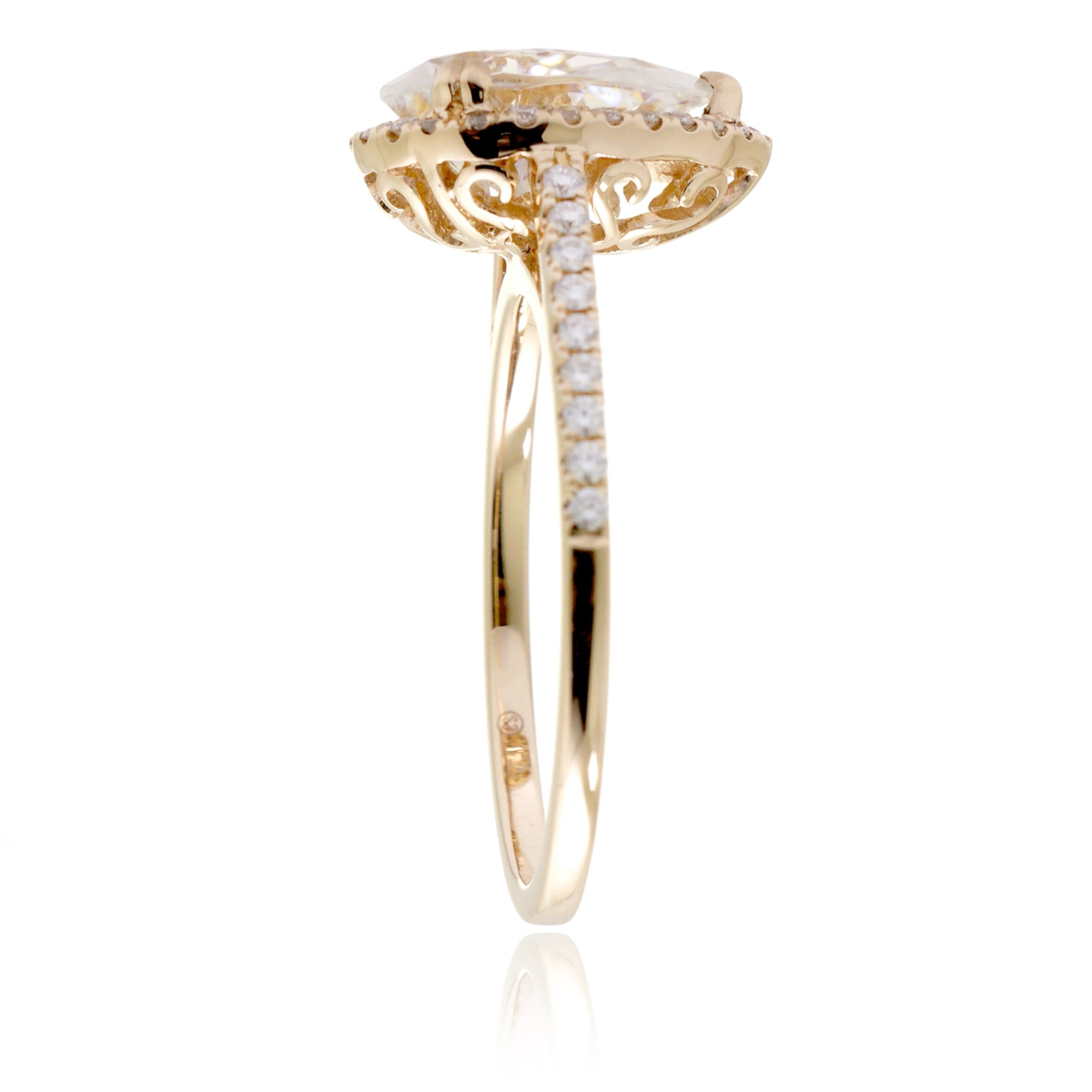 Pear moissanite and diamond halo ring in the signature yellow gold
