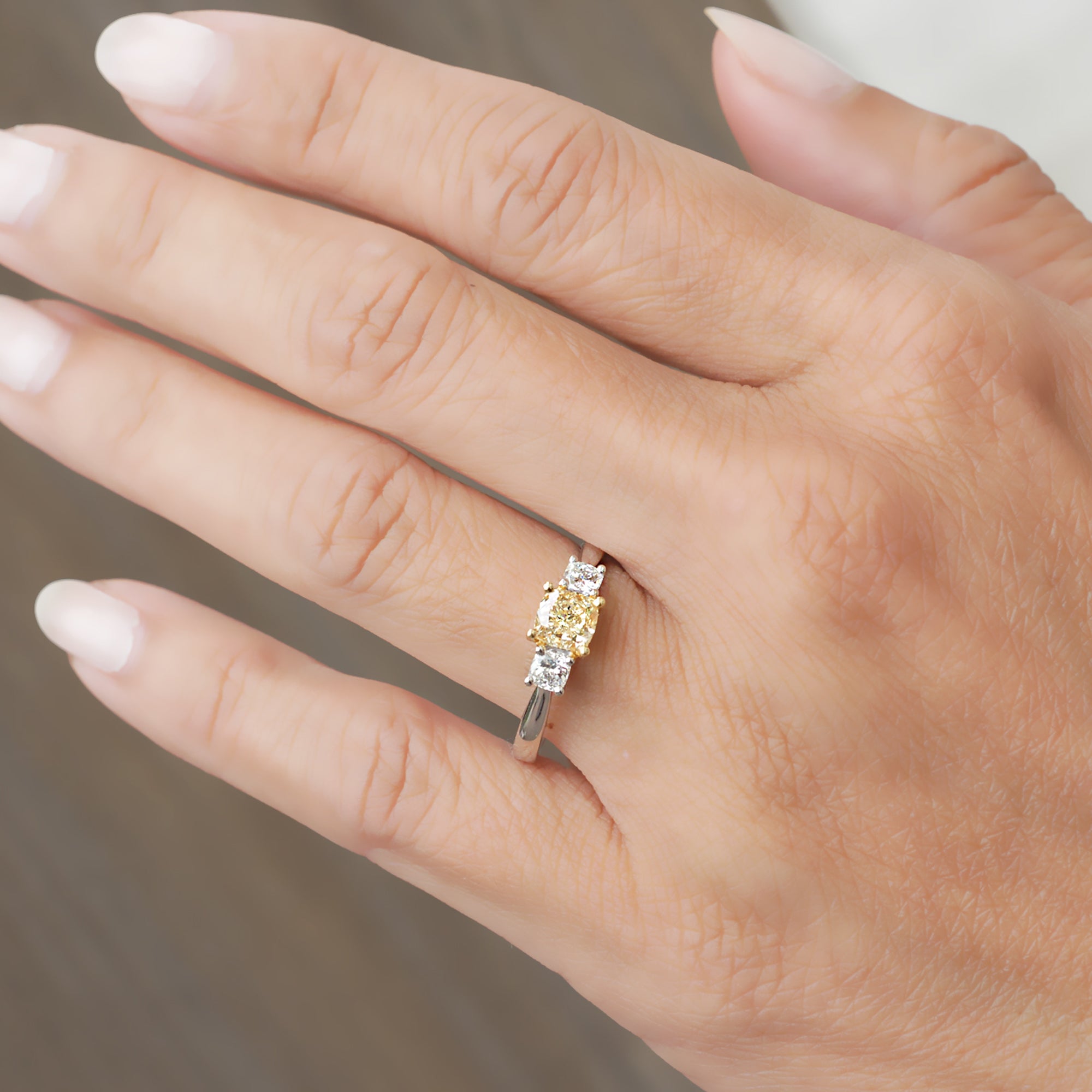 Fancy yellow color natural cushion diamond three stone engagement ring