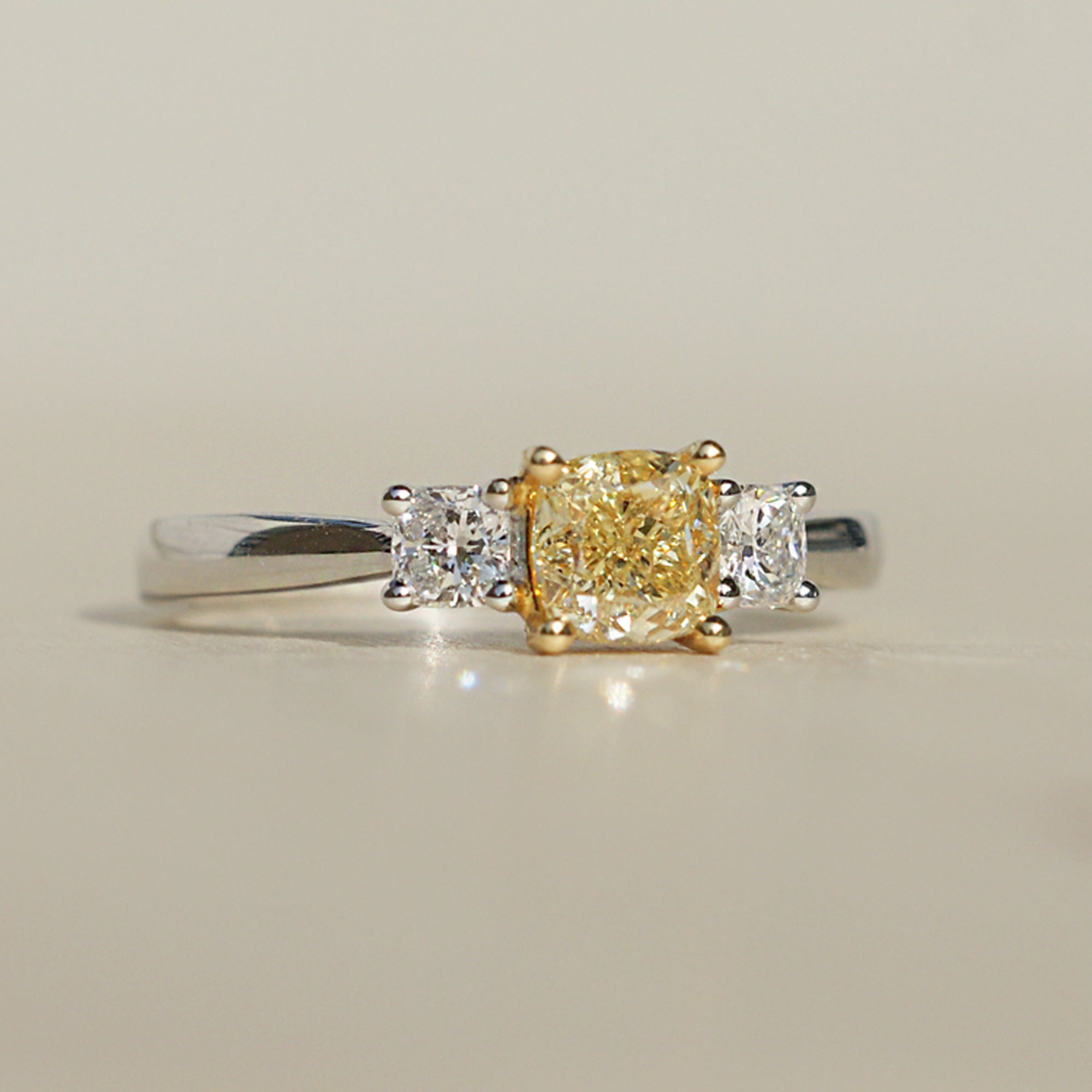 Fancy yellow color natural cushion diamond three stone engagement ring