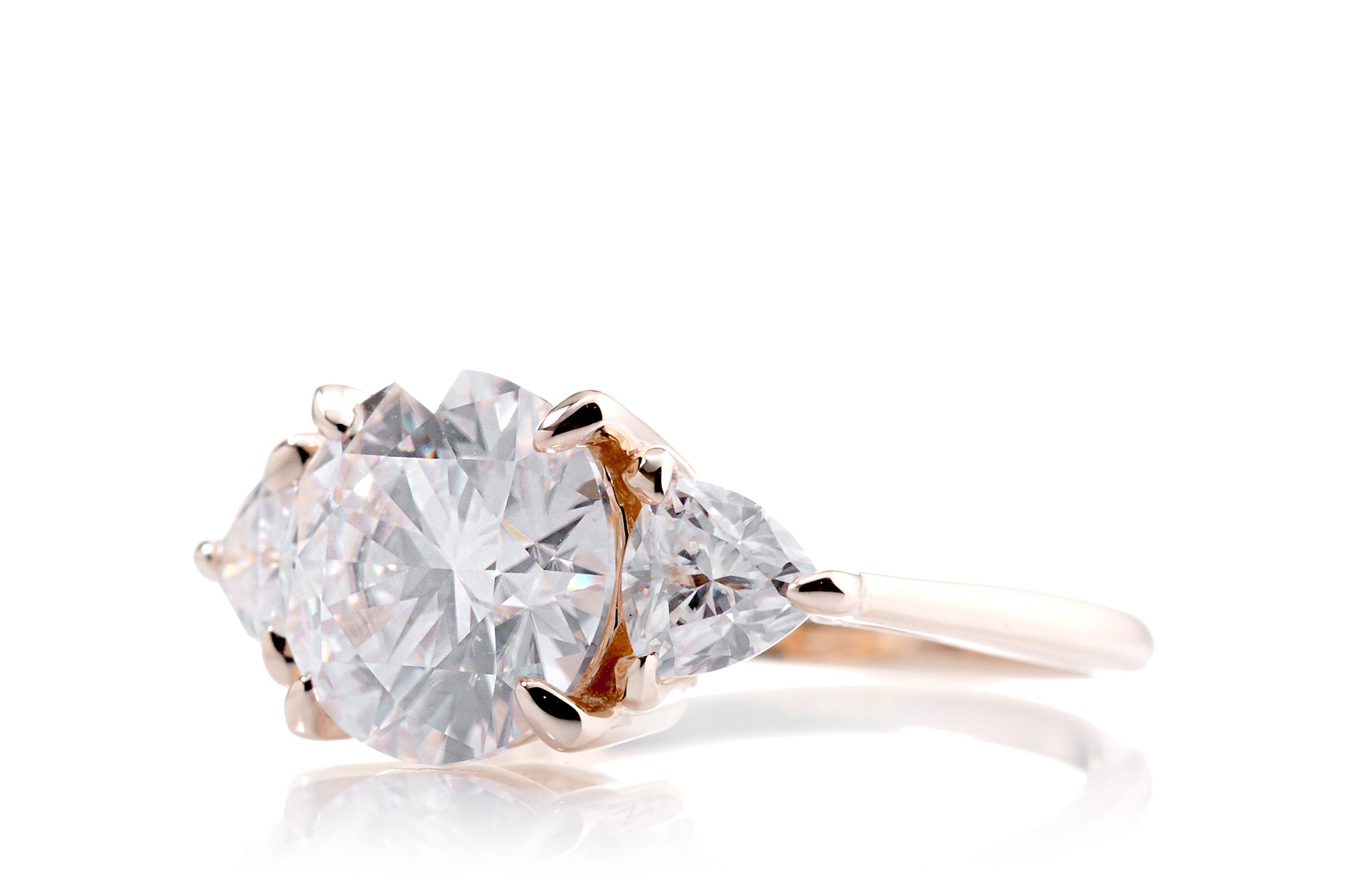 The Trillion Three stone Round Moissanite Ring