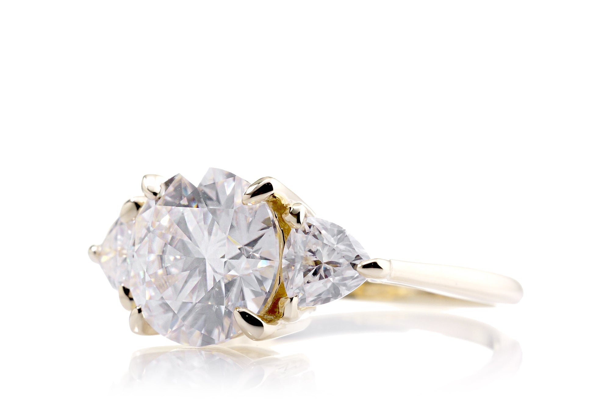 The Trillion Three stone Round Moissanite Ring