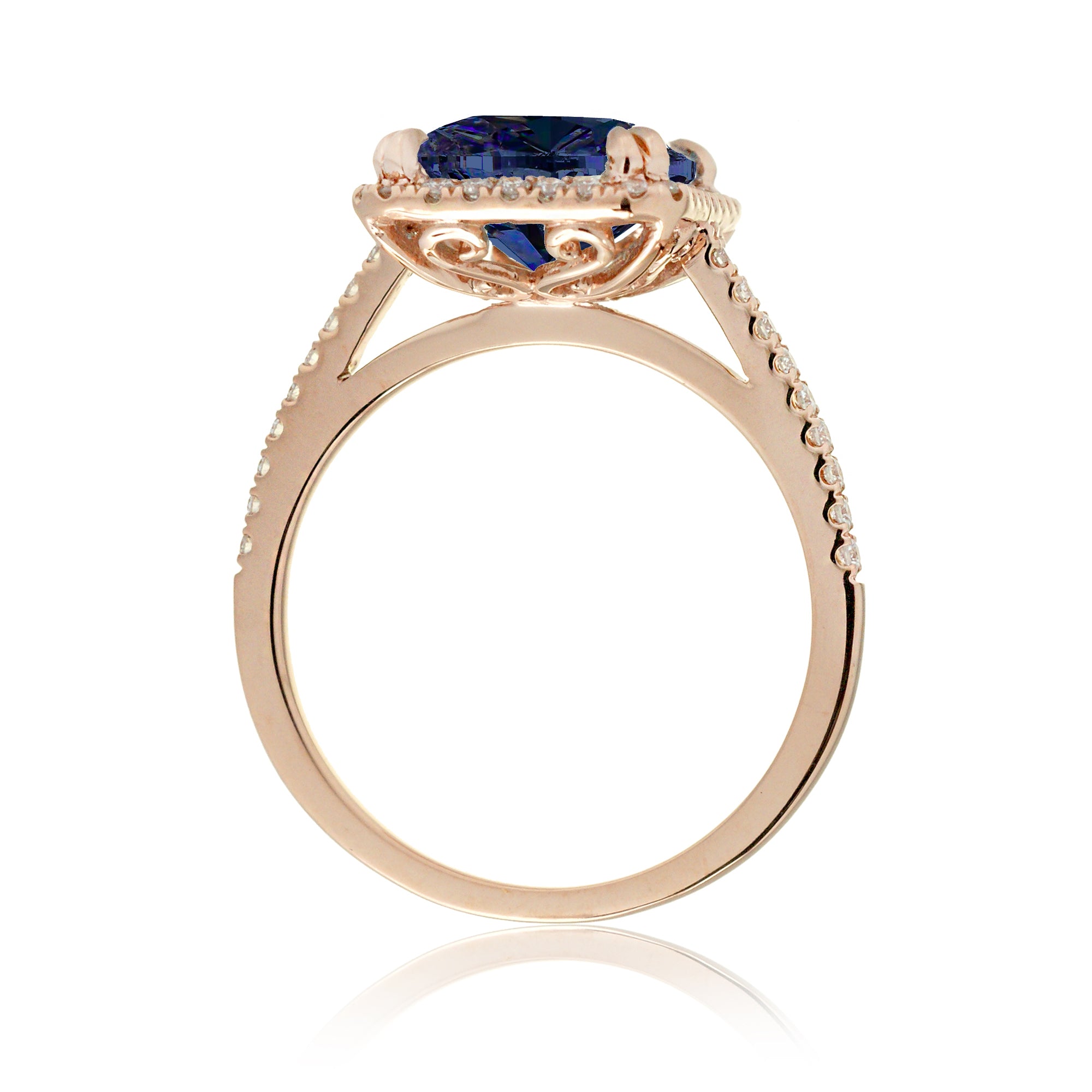 Emerald cut sapphire engagement ring with a diamond halo in rose gold
