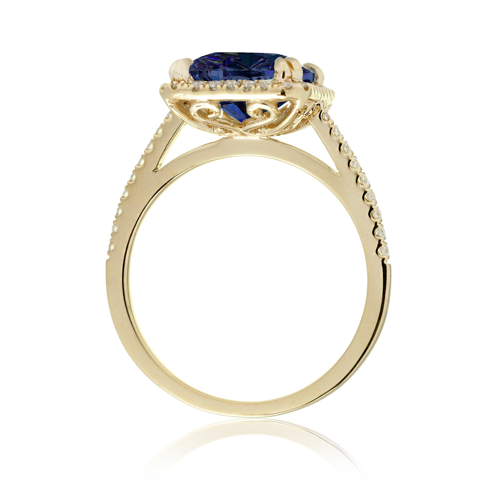 Emerald cut sapphire engagement ring with a diamond halo in yellow gold