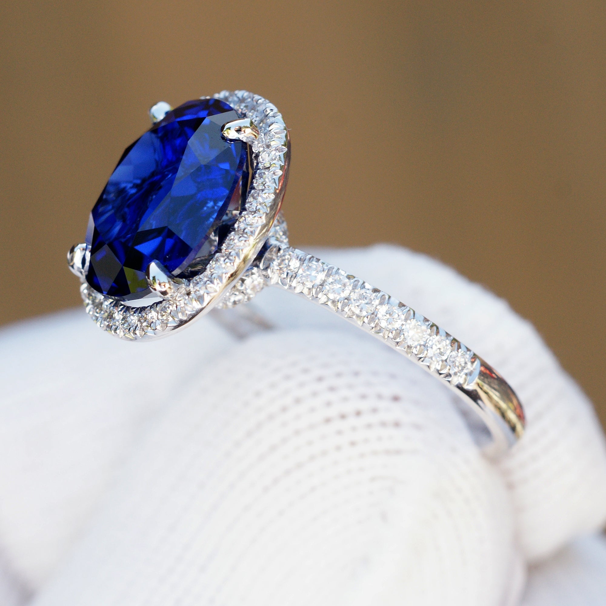Oval Blue Sapphire Statement Ring in Diamond Halo and Platinum