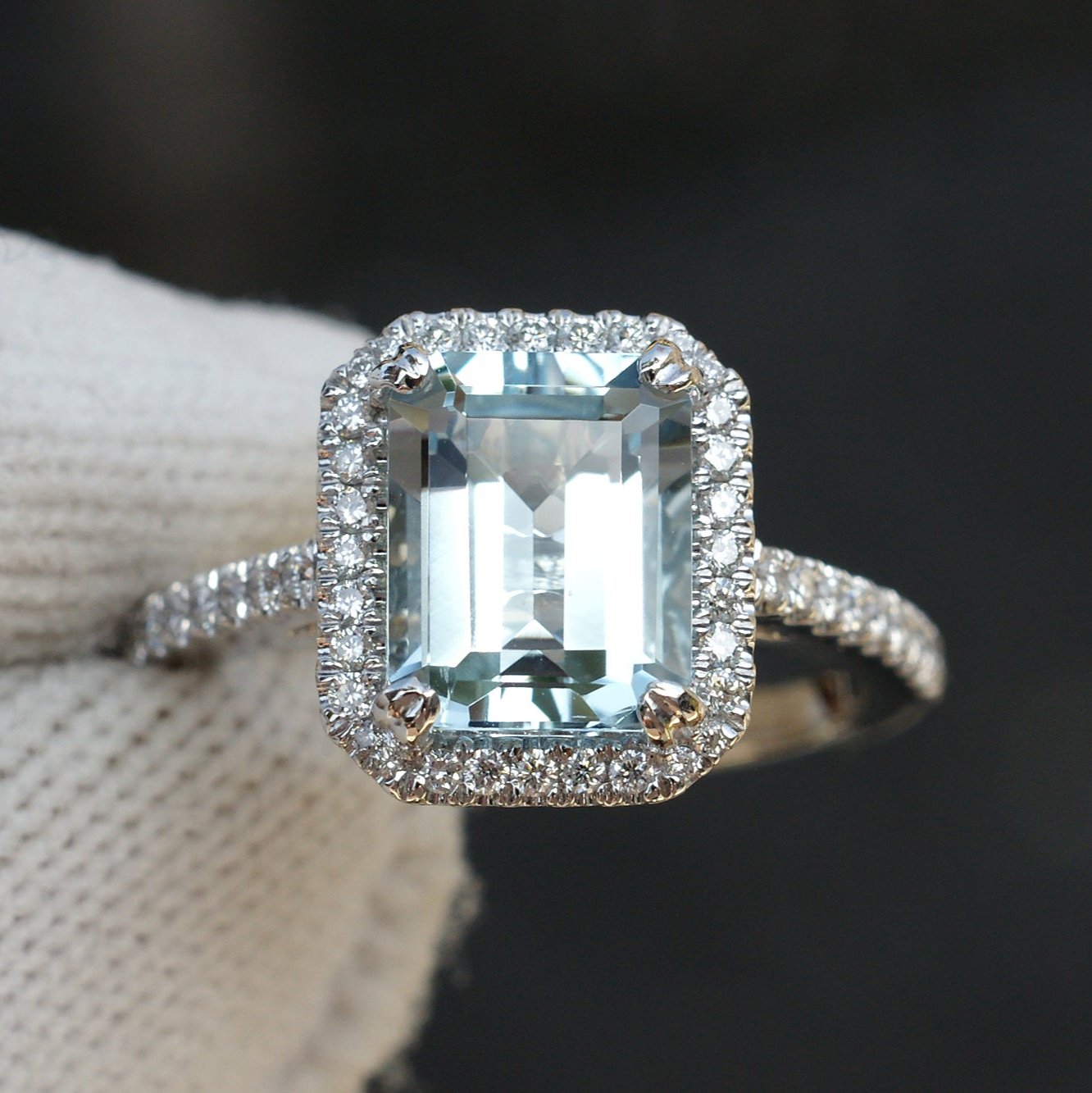 Emerald cut aquamarine engagement ring with diamond halo in white gold