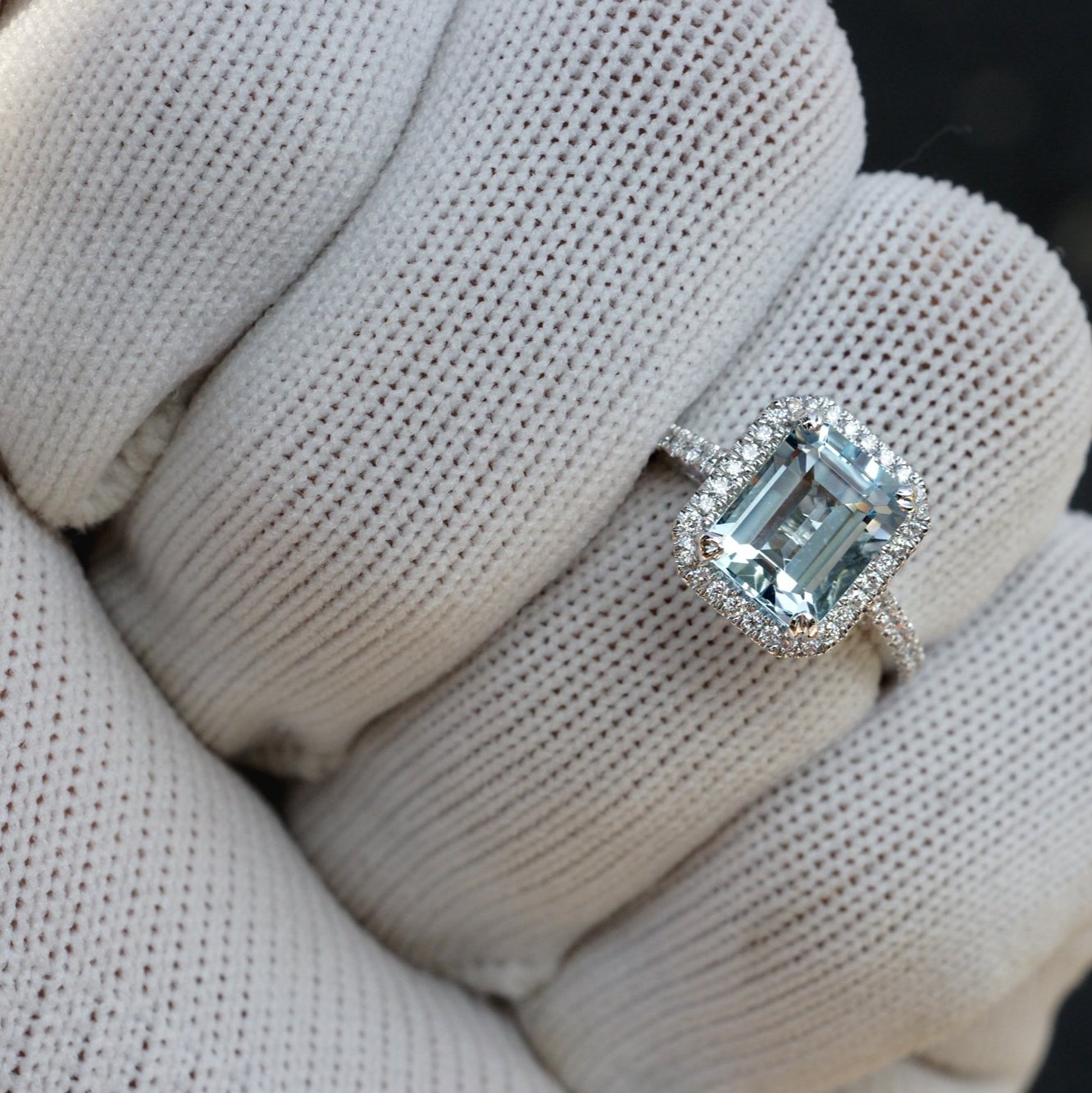 Emerald cut aquamarine engagement ring with diamond halo in white gold