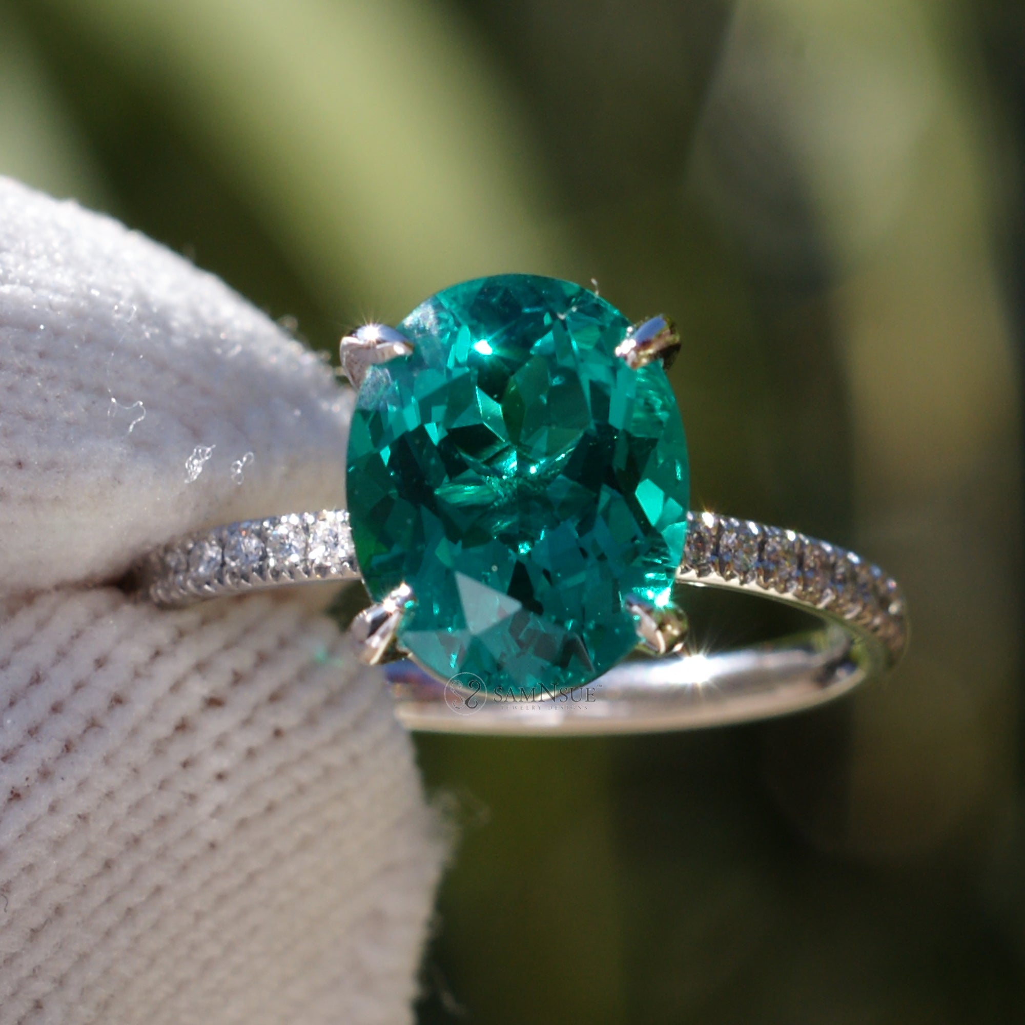 Oval cut lab-grown emerald and diamond solitaire engagement ring platinum