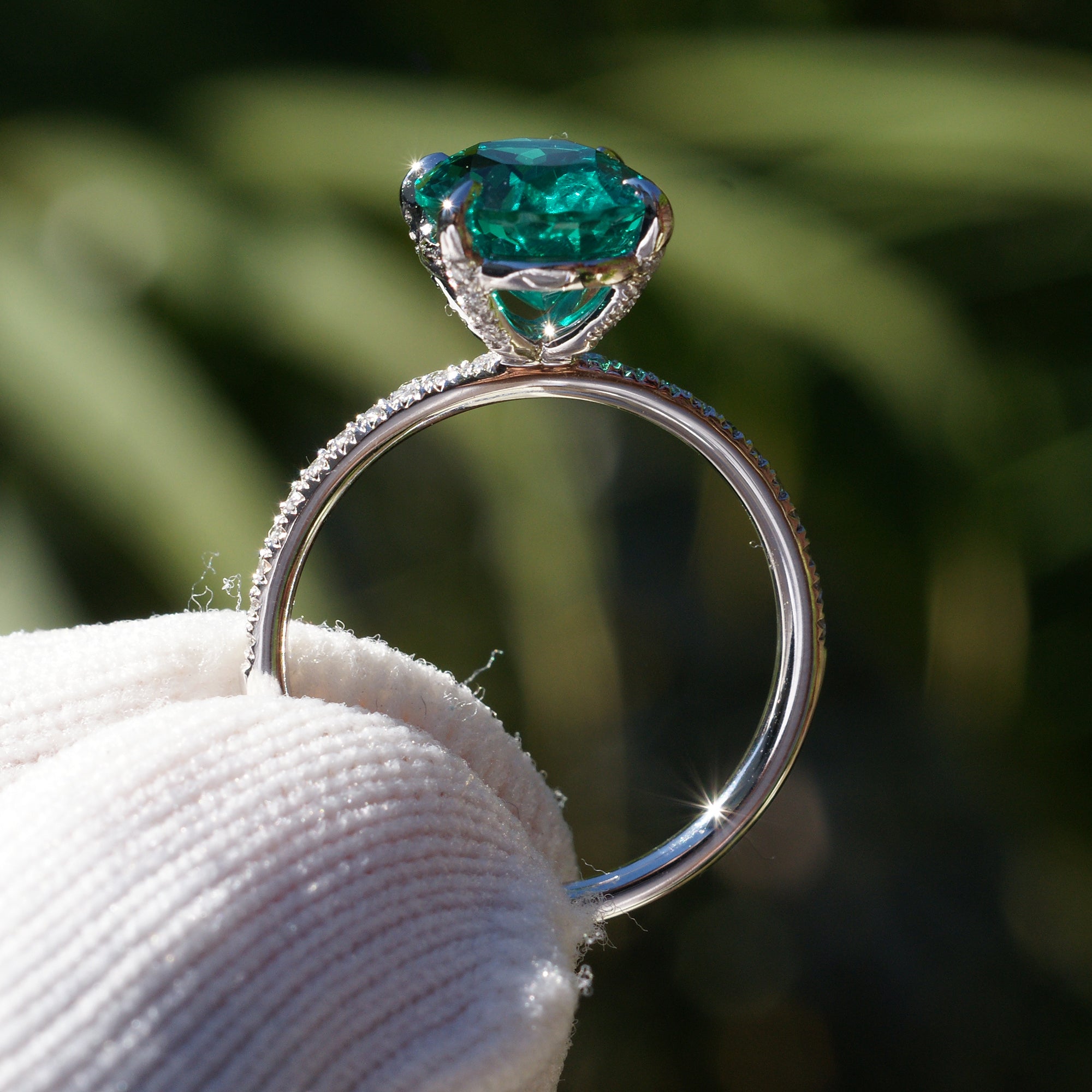 Oval cut lab-grown emerald and diamond solitaire engagement ring platinum