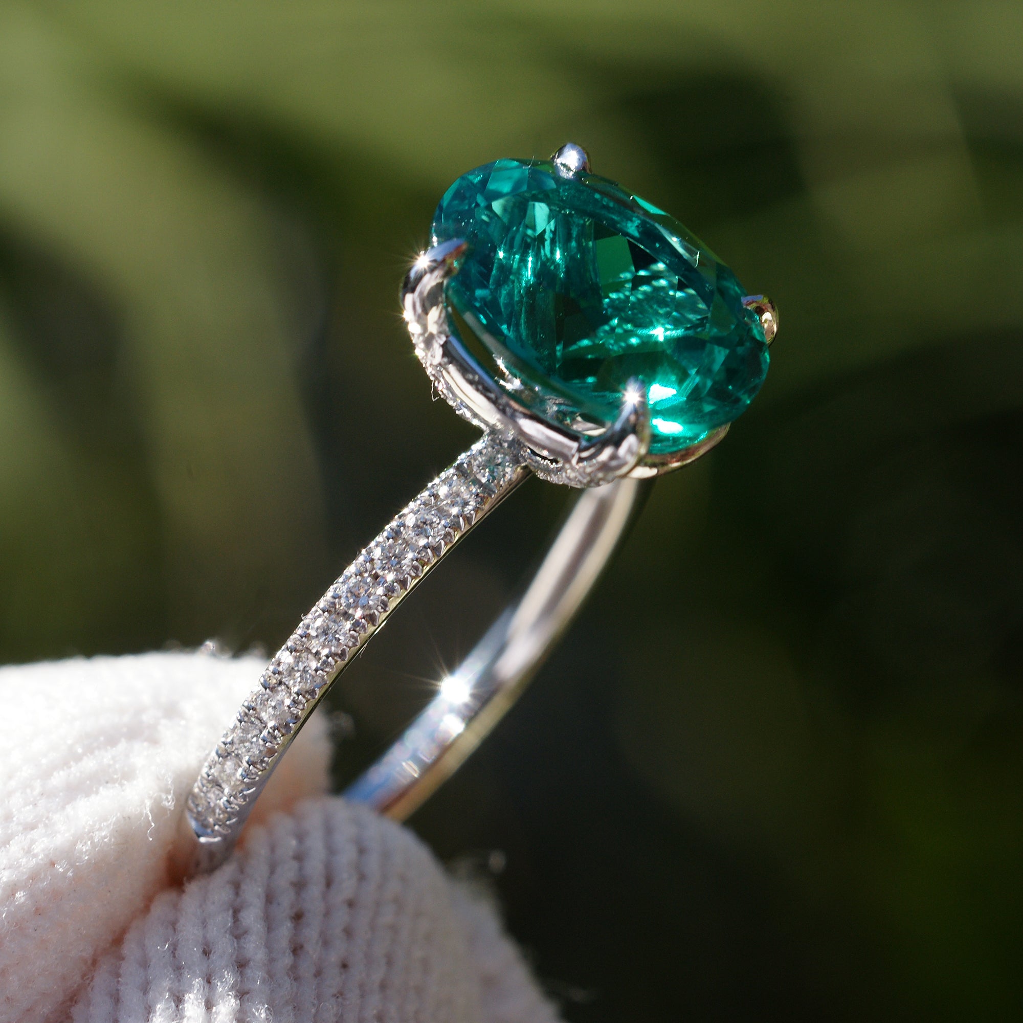 Oval cut lab-grown emerald and diamond solitaire engagement ring platinum