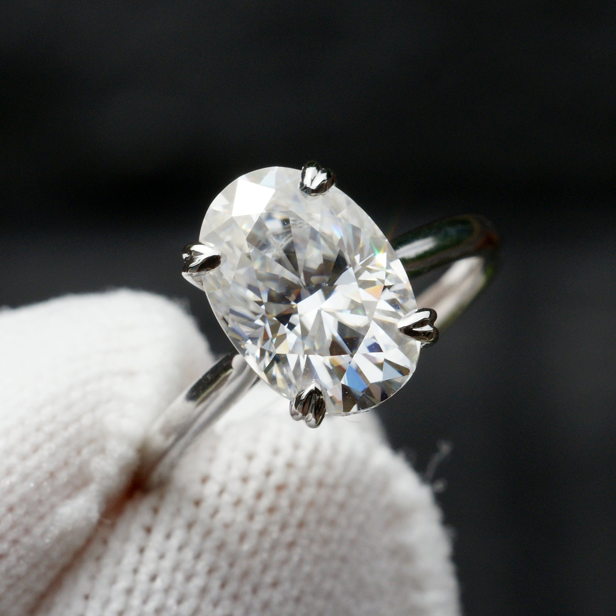 Elongated oval moissanite solitaire hidden halo ring