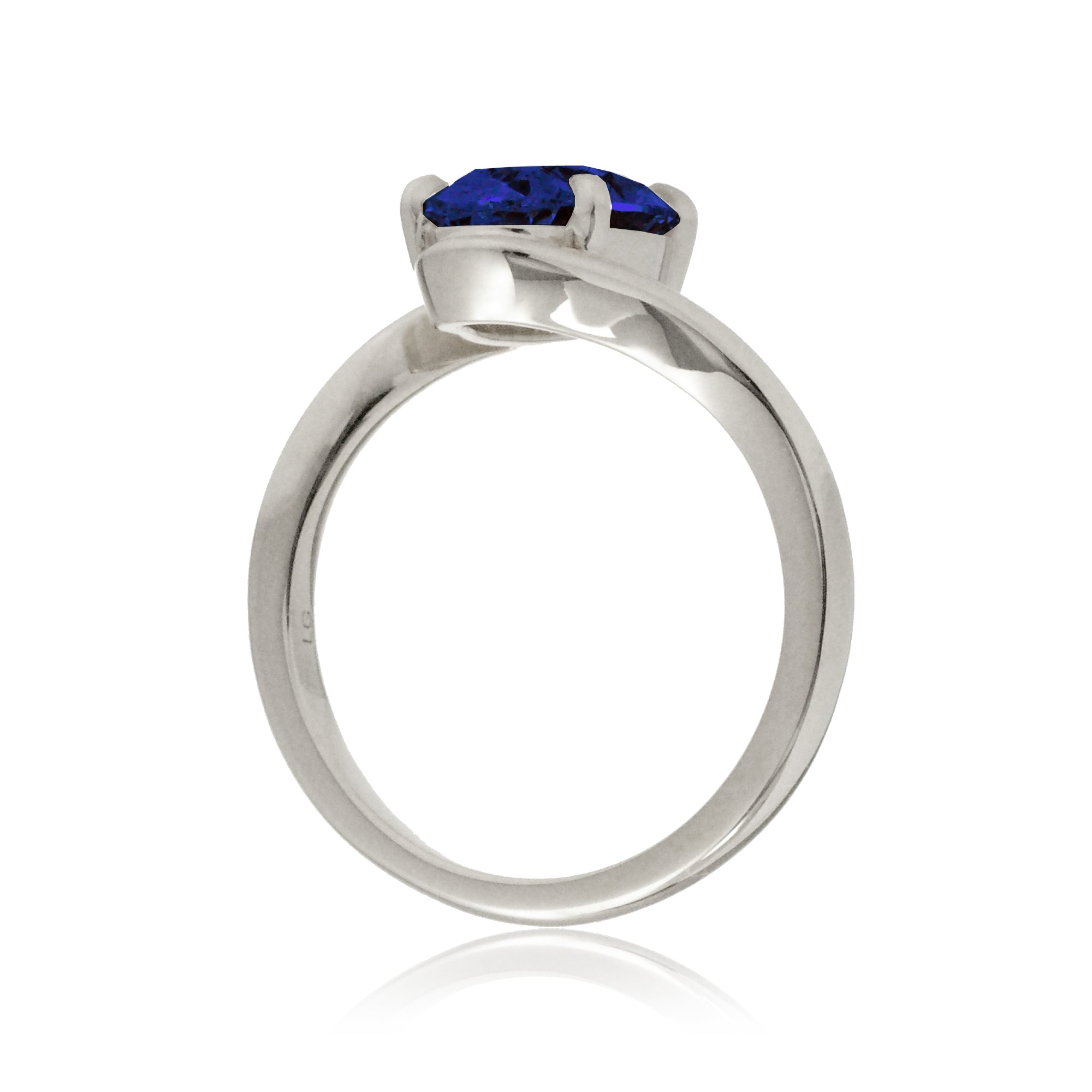 Oval blue sapphire ring in a modern bypass setting with white gold band
