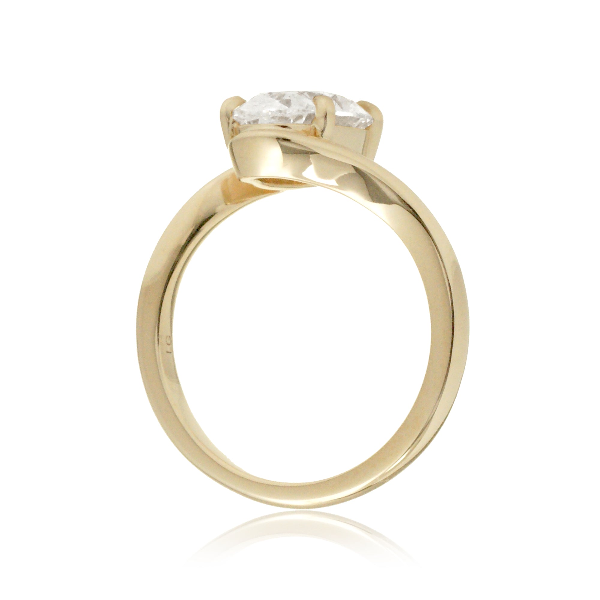Elegant bypass-style oval diamond ring with polished yellow gold shank