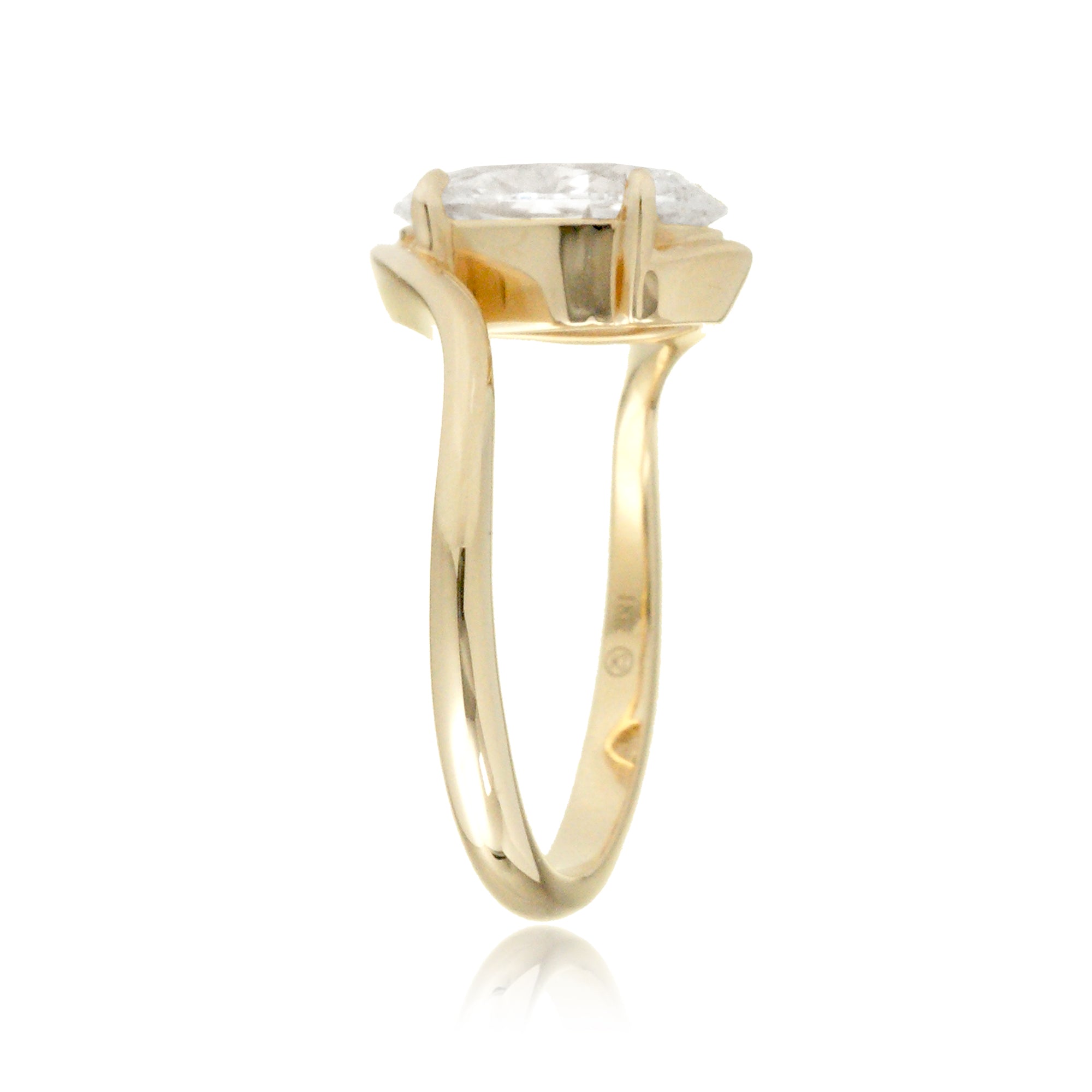 Elegant bypass-style oval diamond ring with polished yellow gold shank