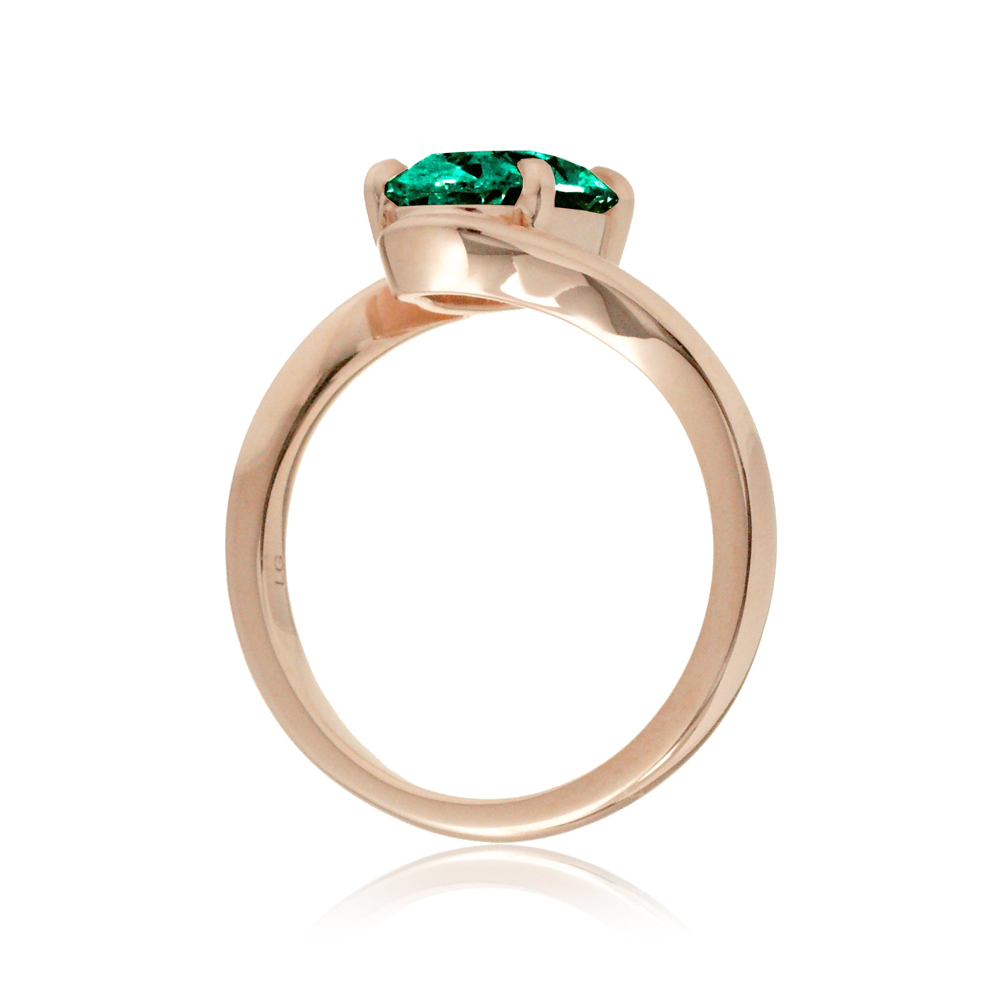 Modern bypass engagement ring with oval emerald in rose gold