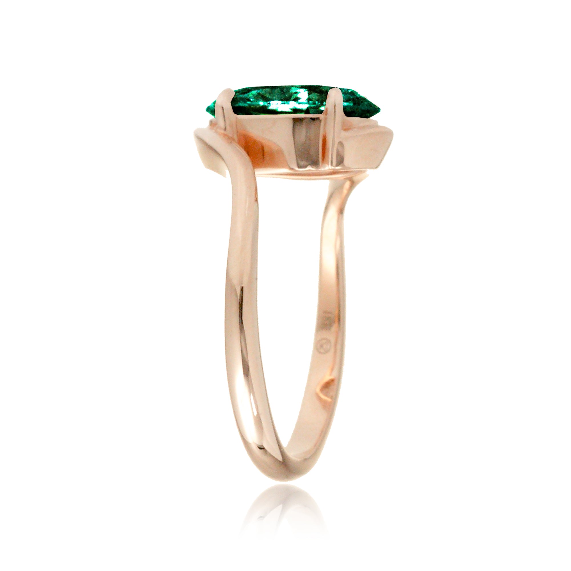 Modern bypass engagement ring with oval emerald in rose gold