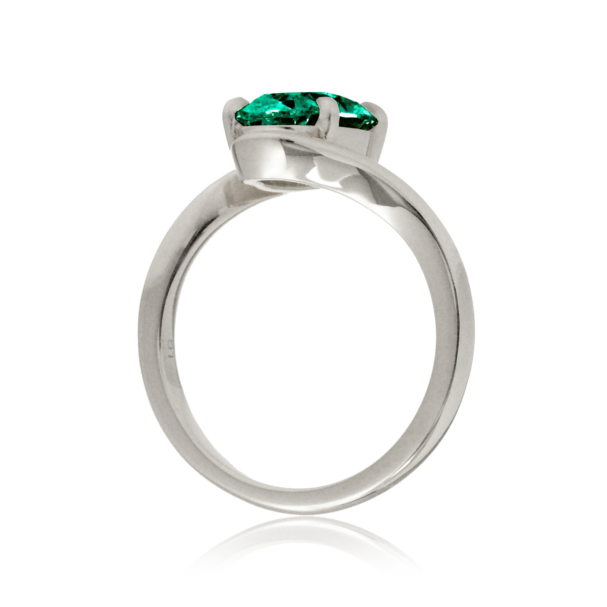 Oval emerald ring in a sleek bypass setting with white gold band