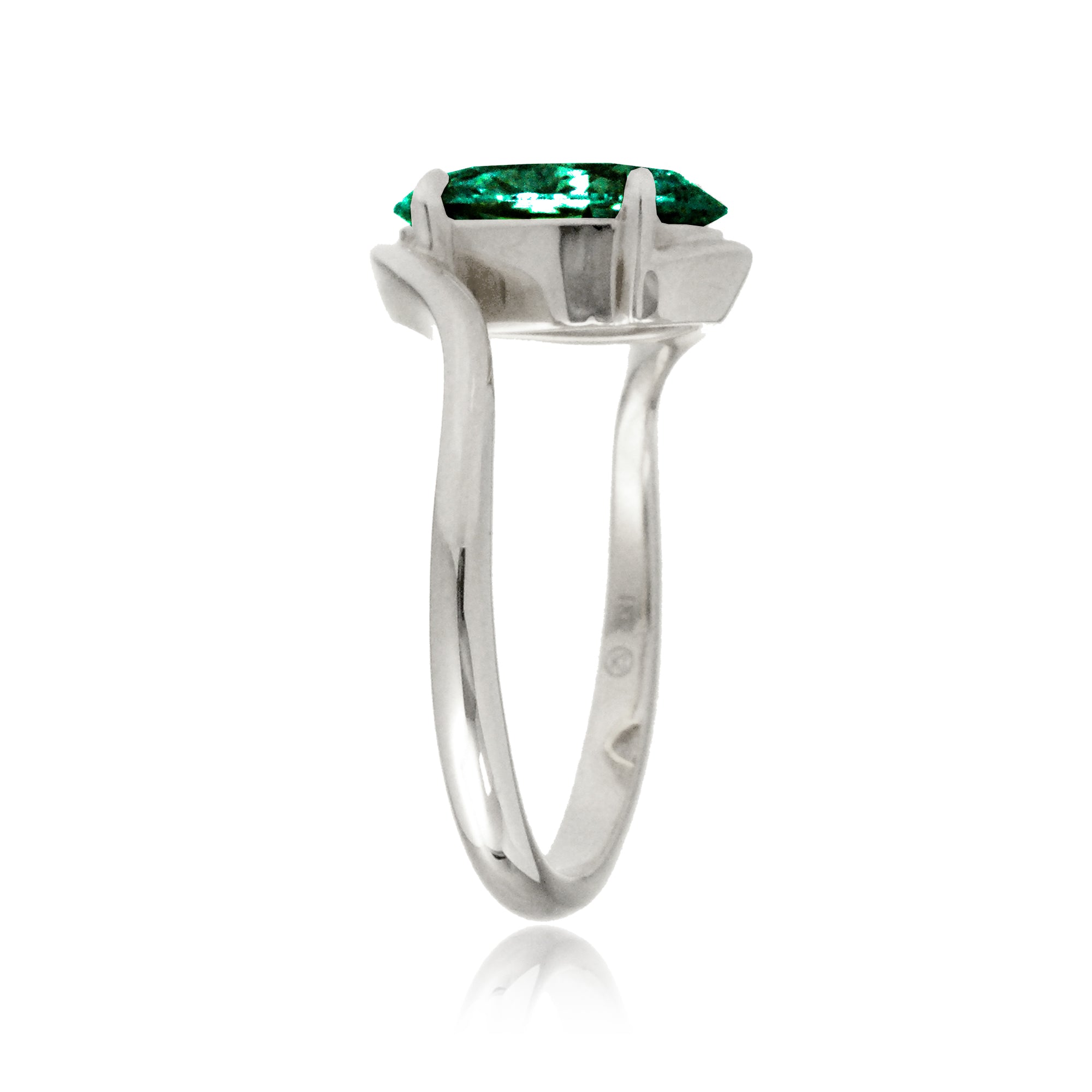 Oval emerald ring in a sleek bypass setting with white gold band