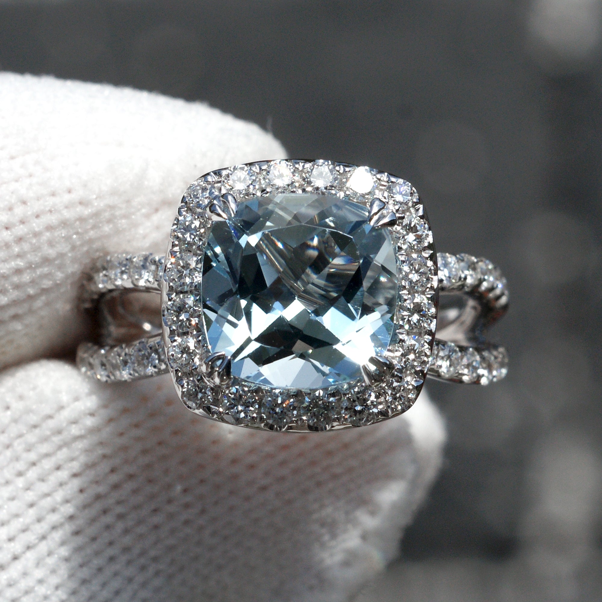 Natural aquamarine and diamond engagement anniversary ring in 18k white gold with a halo and splitband