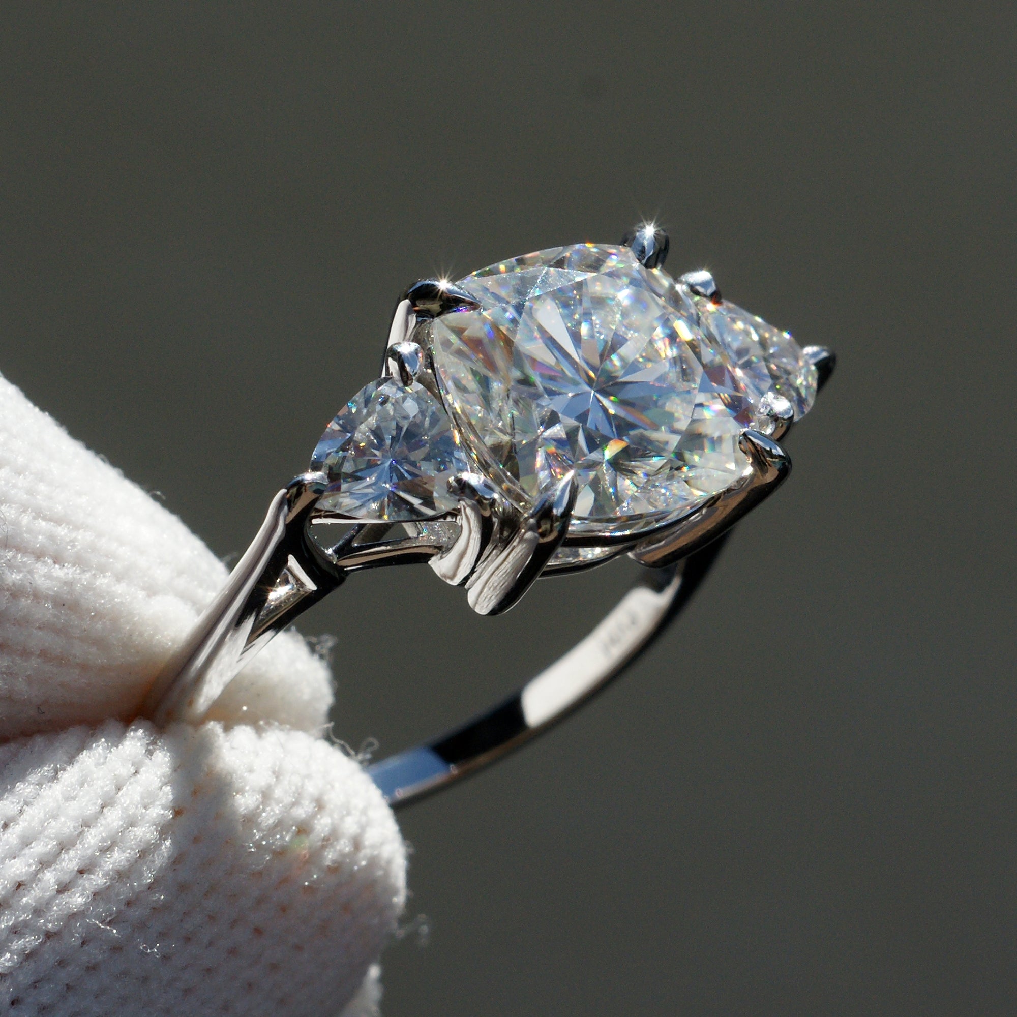 Cushion moissanite three stone ring with trillion on each side in white gold