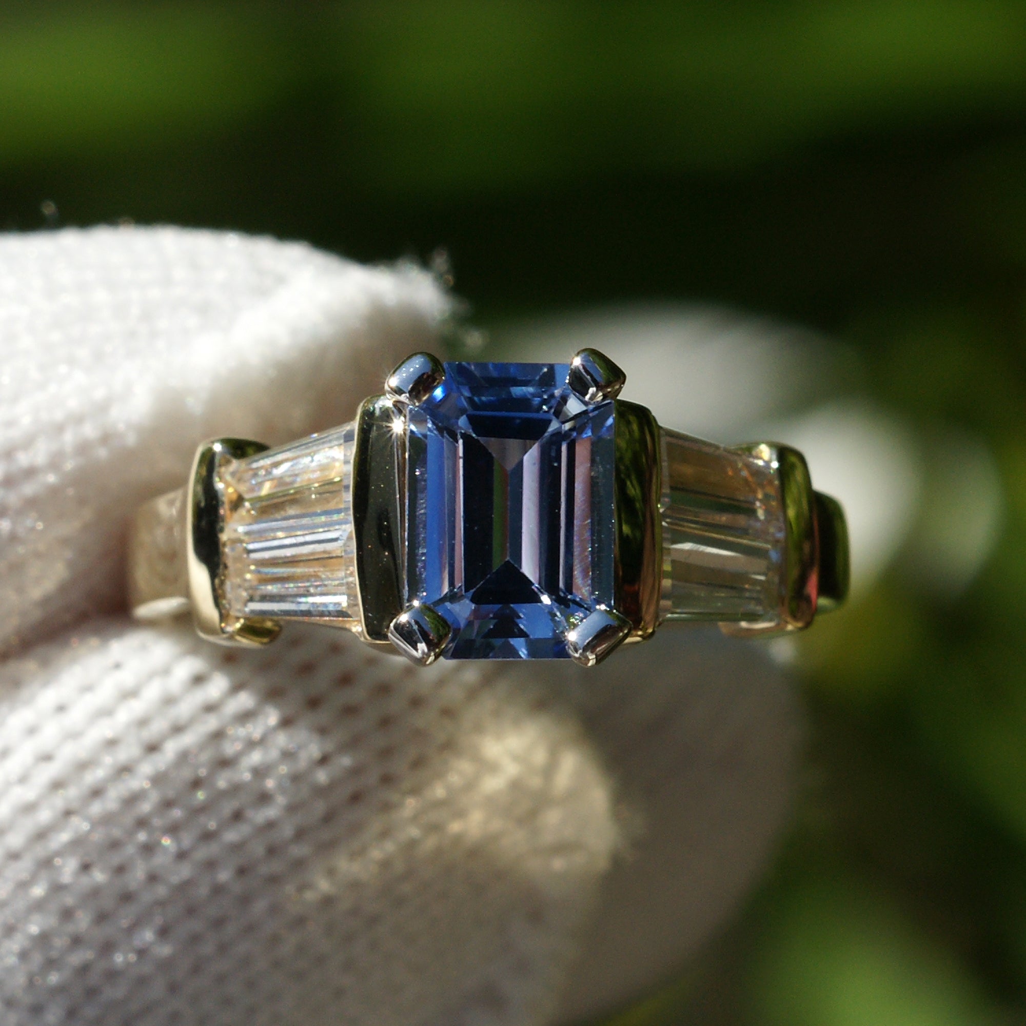 Natural sapphire and diamond baguette three stone ring in yellow gold