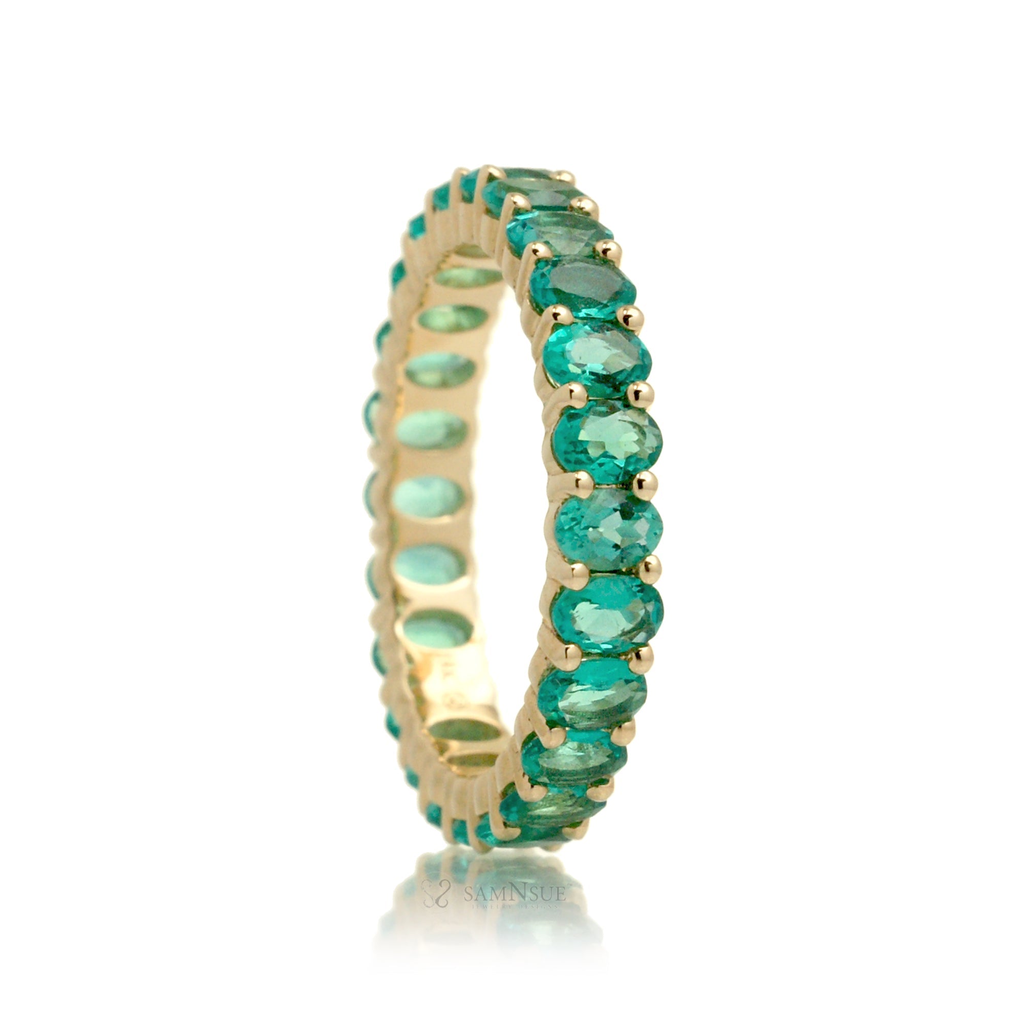 Emerald oval cut eternity band yellow gold