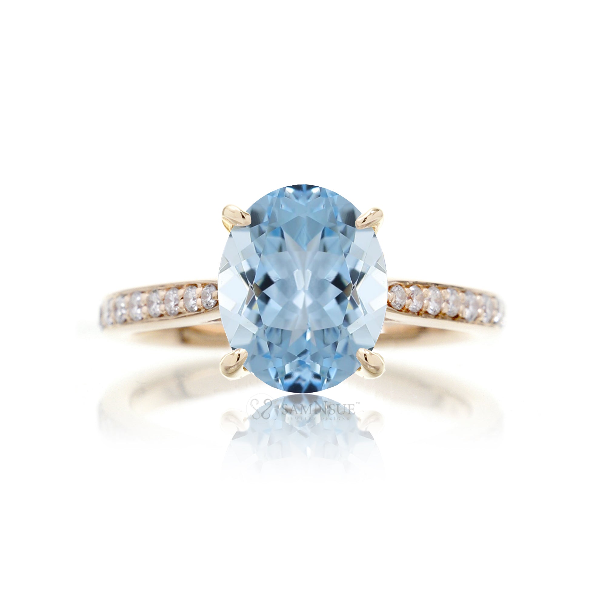 Oval cut aquamarine ring with a diamond band yellow gold