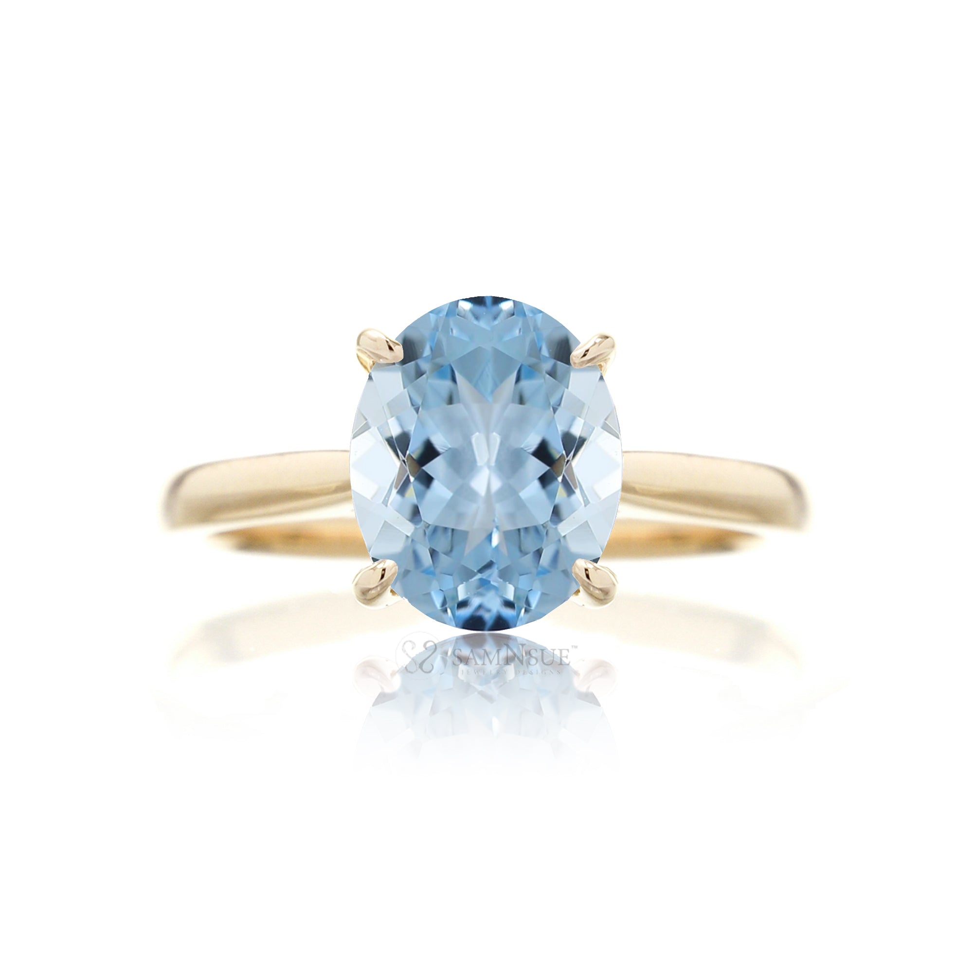 Oval cut aquamarine ring with a solid 
band yellow gold