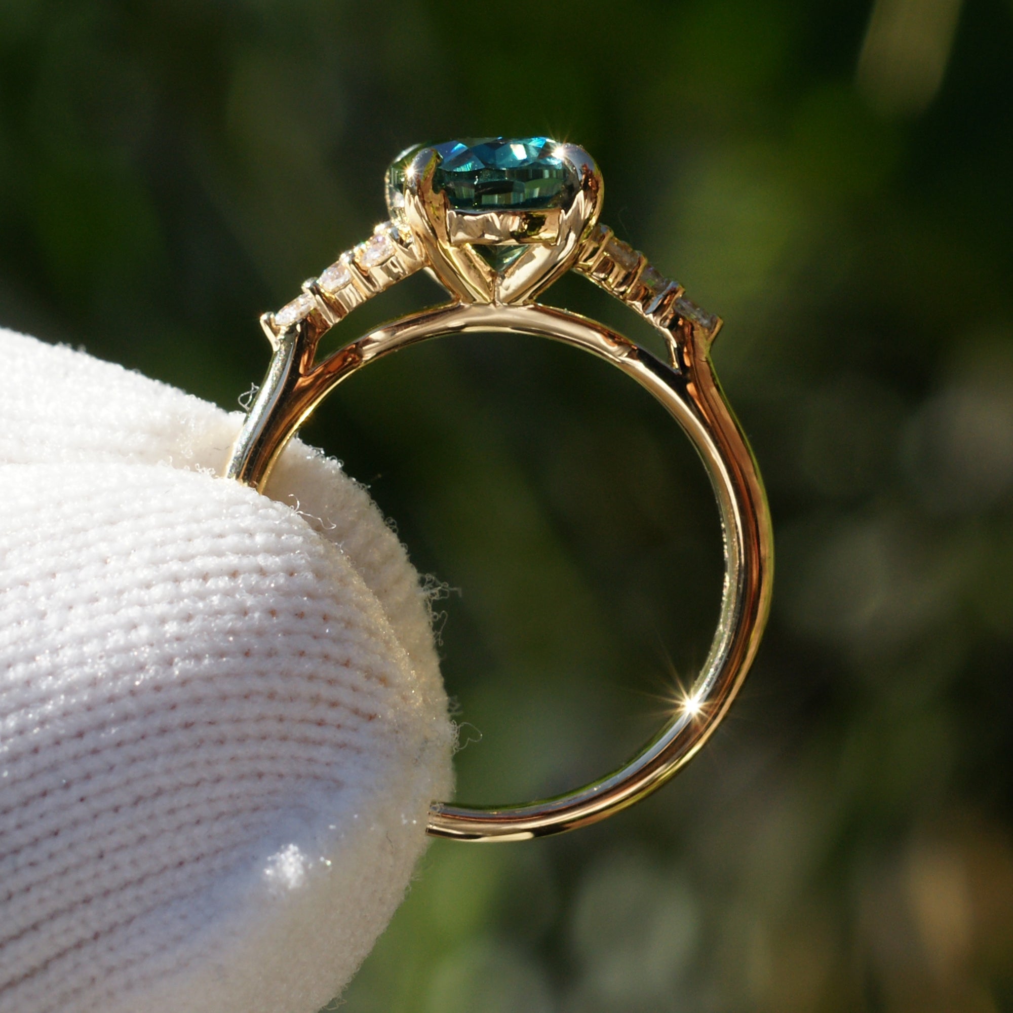 Oval cut green sapphire diamond three stone ring yellow gold