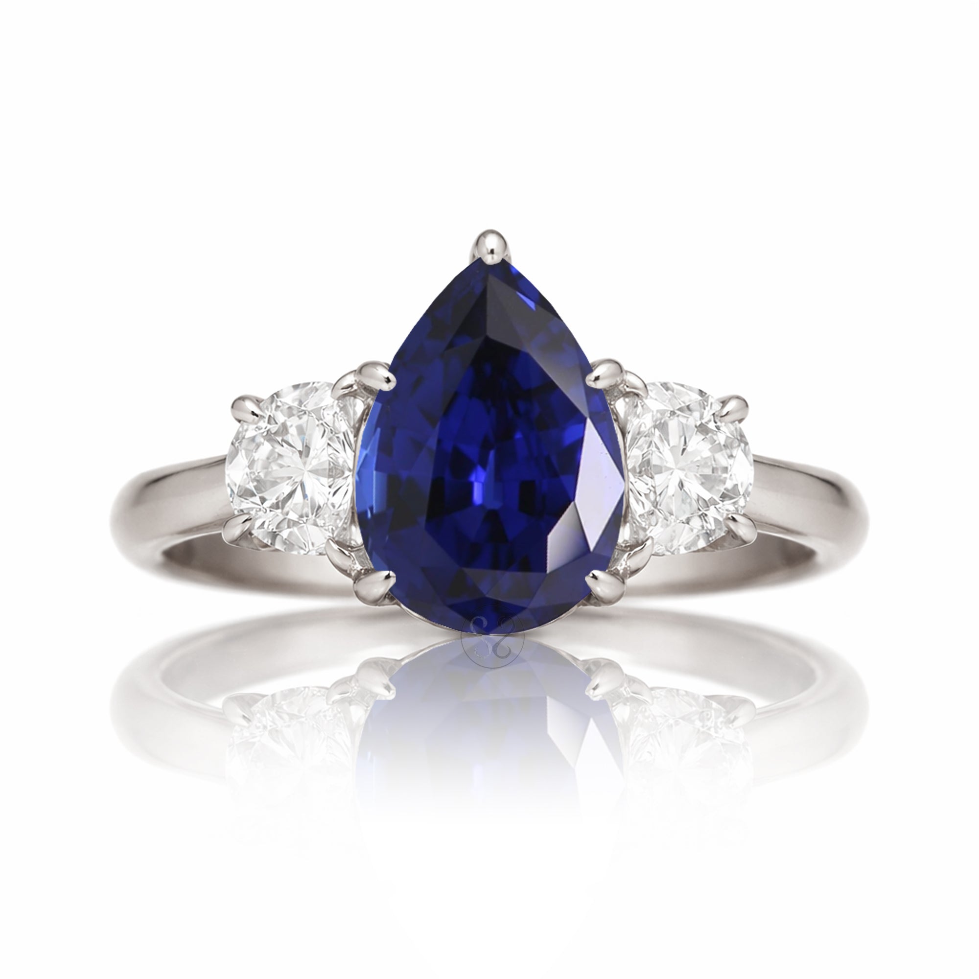 Pear blue sapphire half moon diamond three stone ring white gold