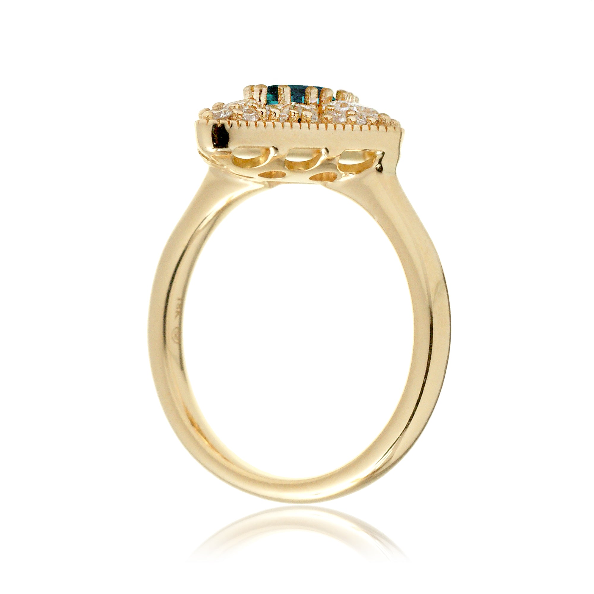 Kite cut green emerald and diamond vintage halo ring in yellow gold