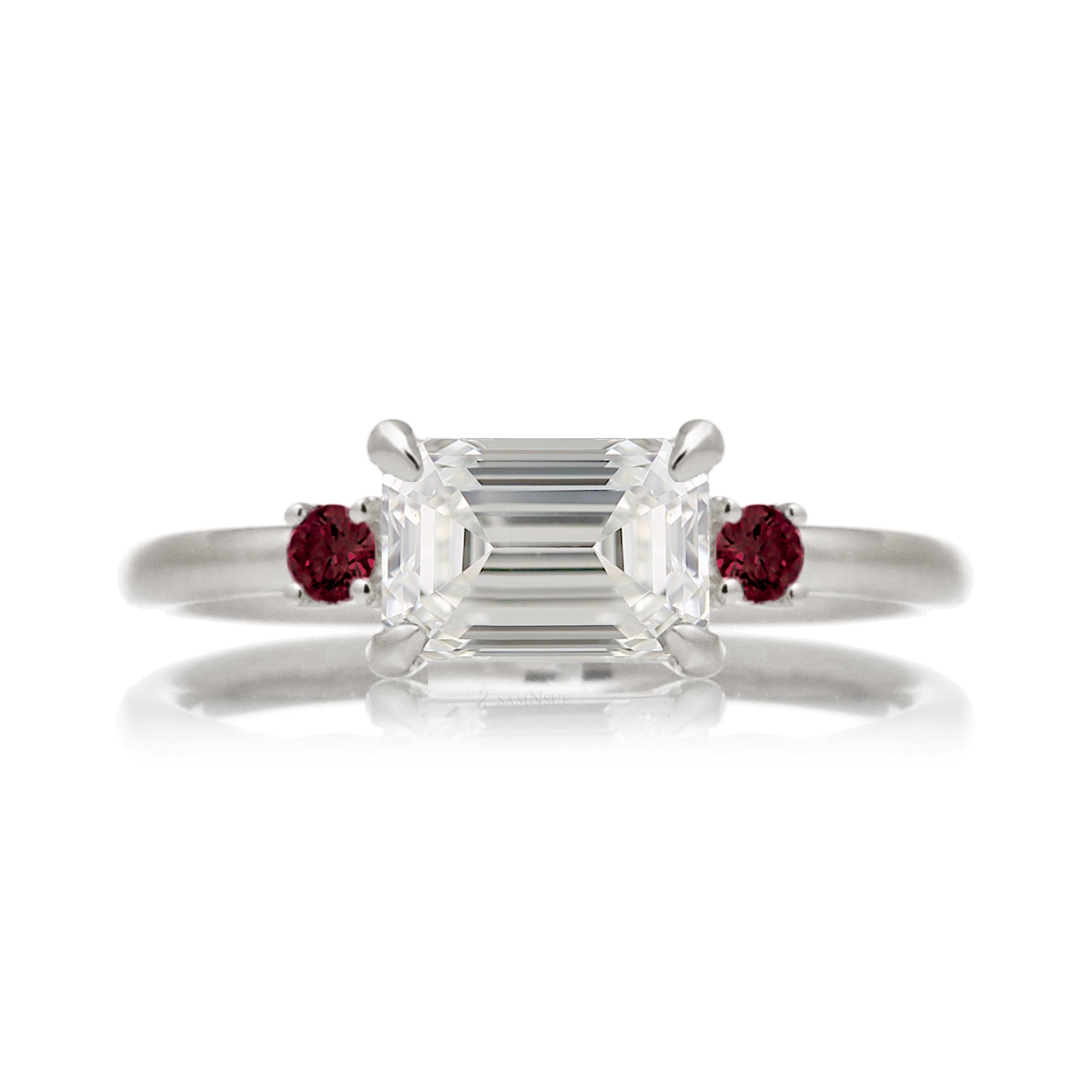 east-west emerald cut diamond three stone ring the Lena with side red rubies white gold