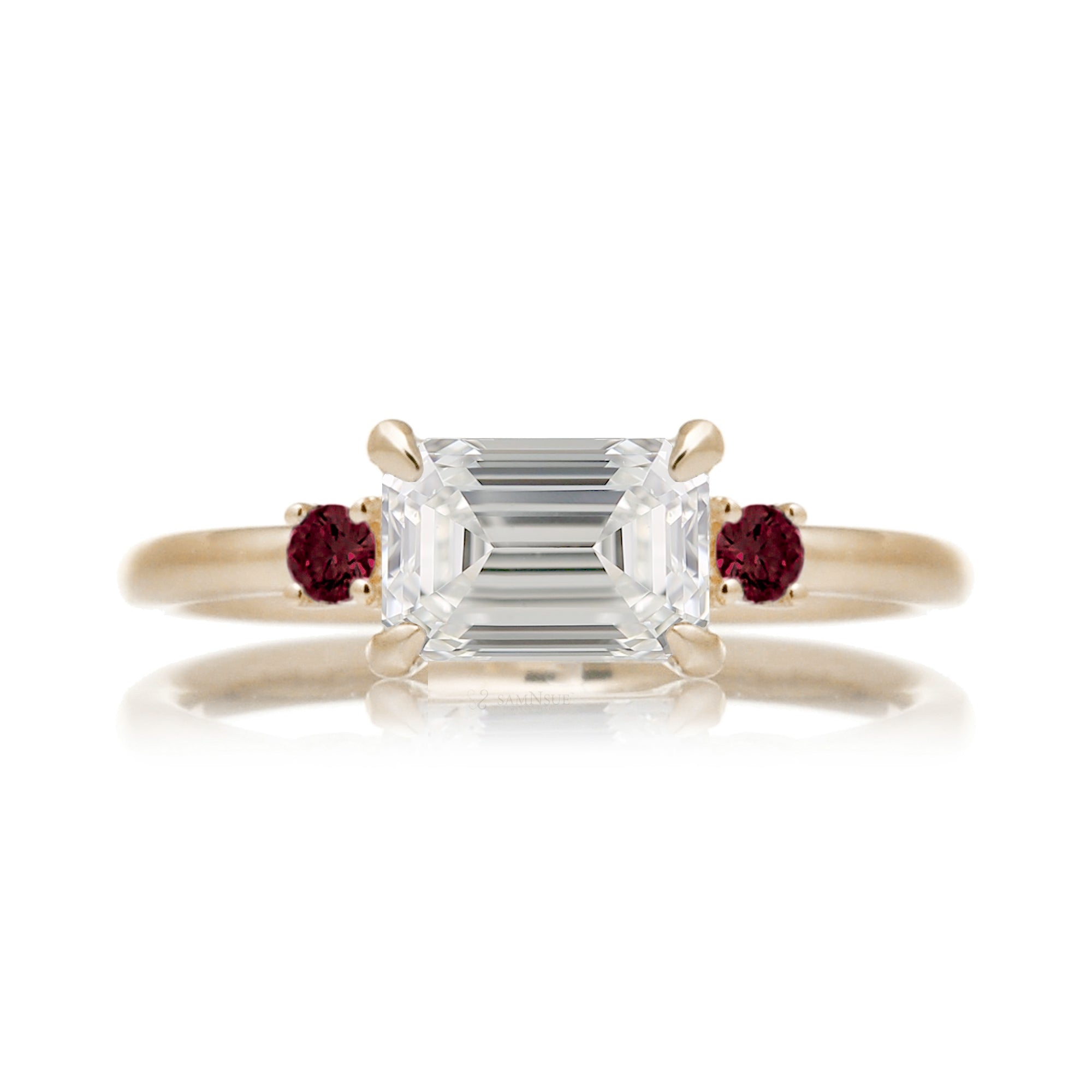 east-west emerald cut diamond three stone ring the Lena with side red rubies yellow gold