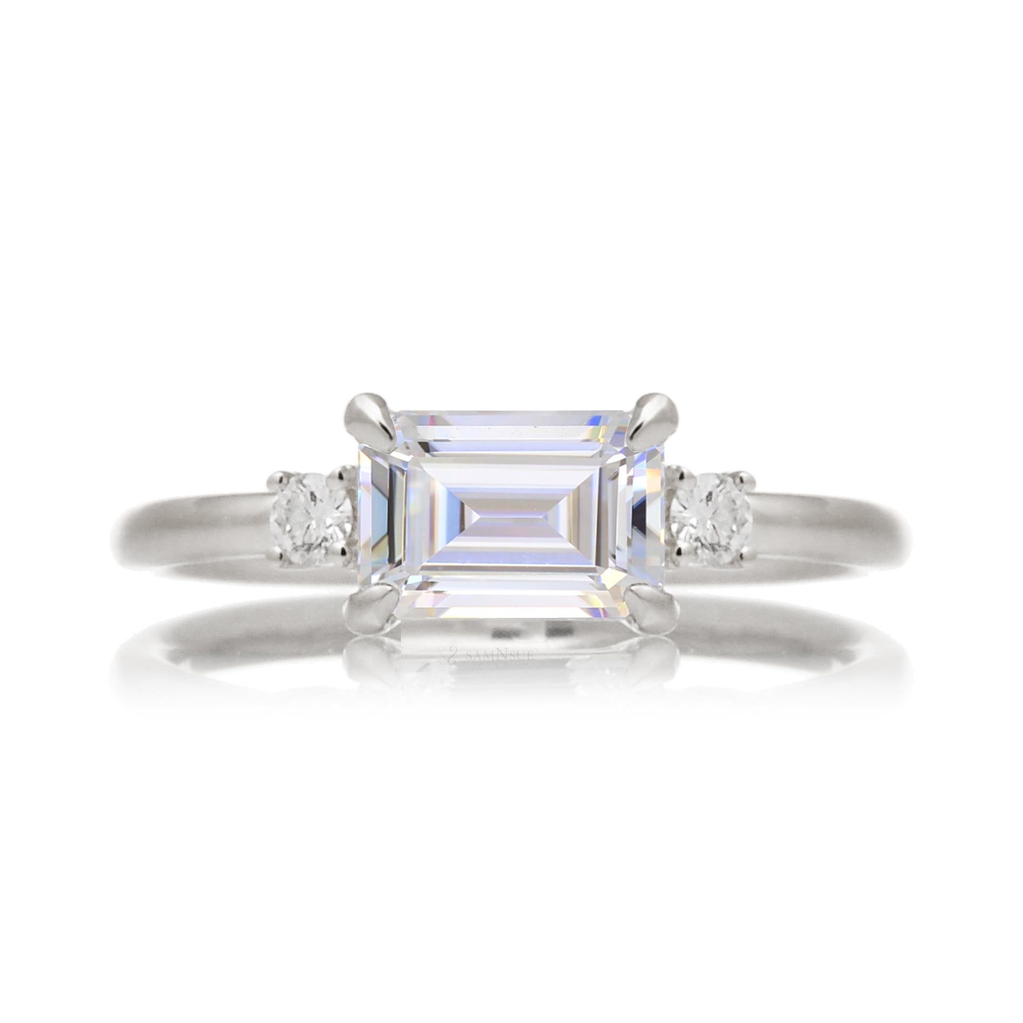 Emerald step cut moissanite three stone east-west ring the Lena white gold