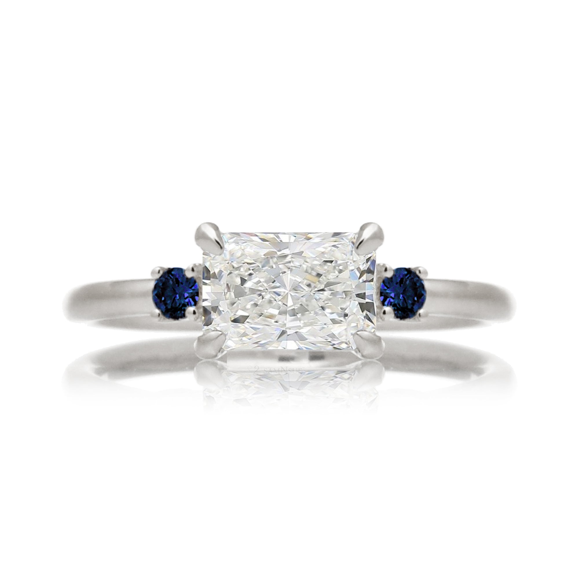 east-west radiant cut lab-grown diamond threestone ring with side blue sapphires white gold