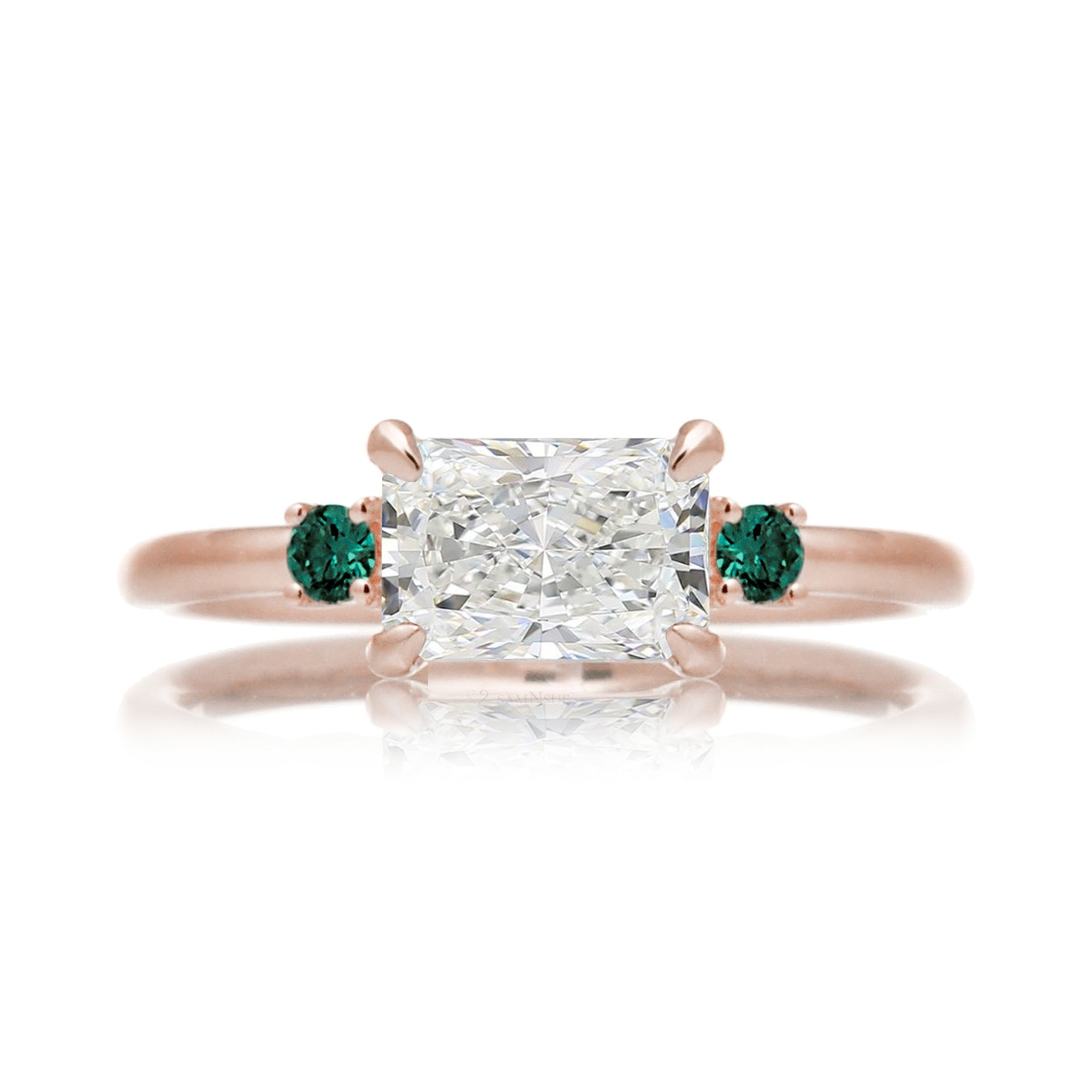 east-west radiant cut lab-grown diamond threestone ring with green emerald rose gold