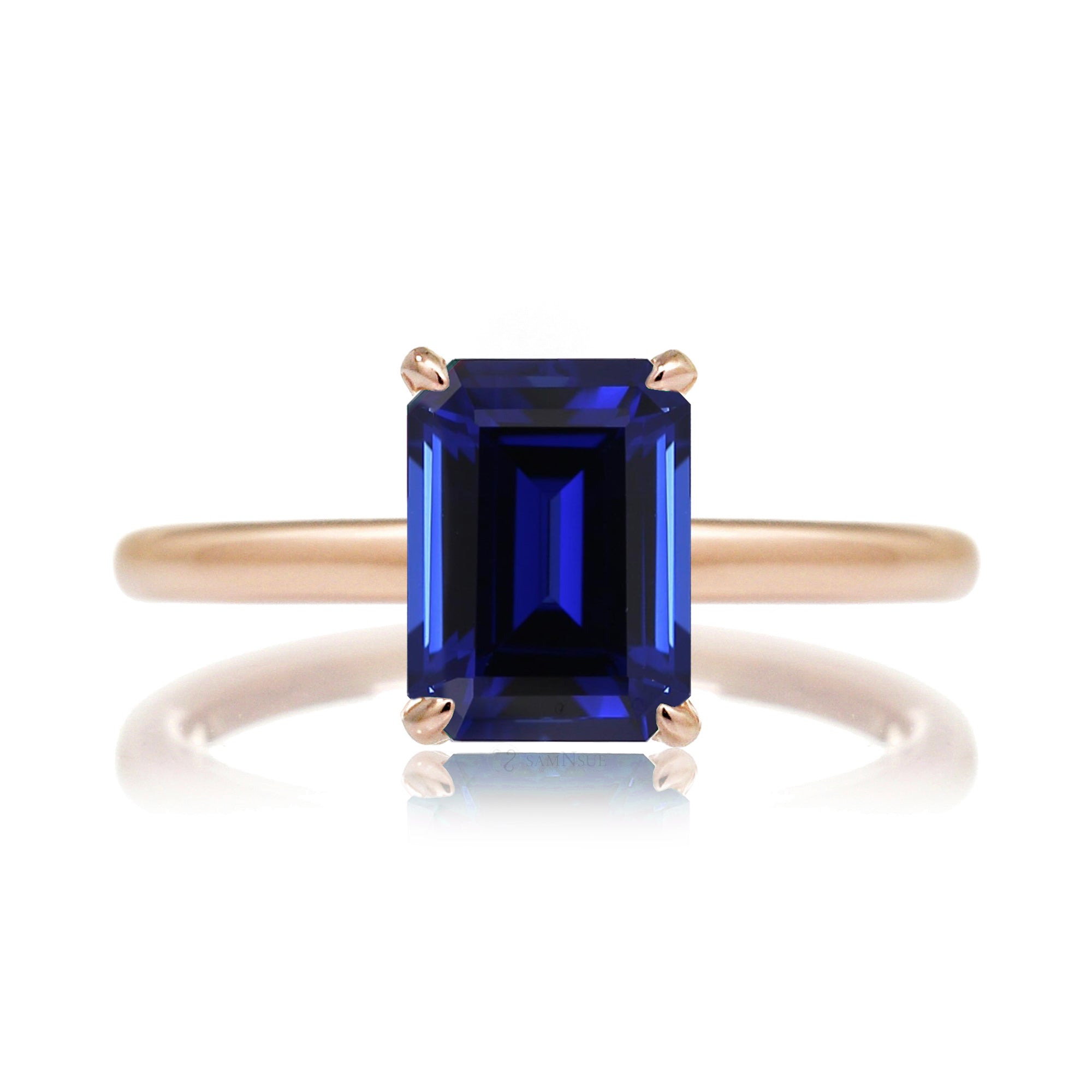 Emerald step cut blue sapphire engagement solitaire ring with hidden diamond halo in rose gold