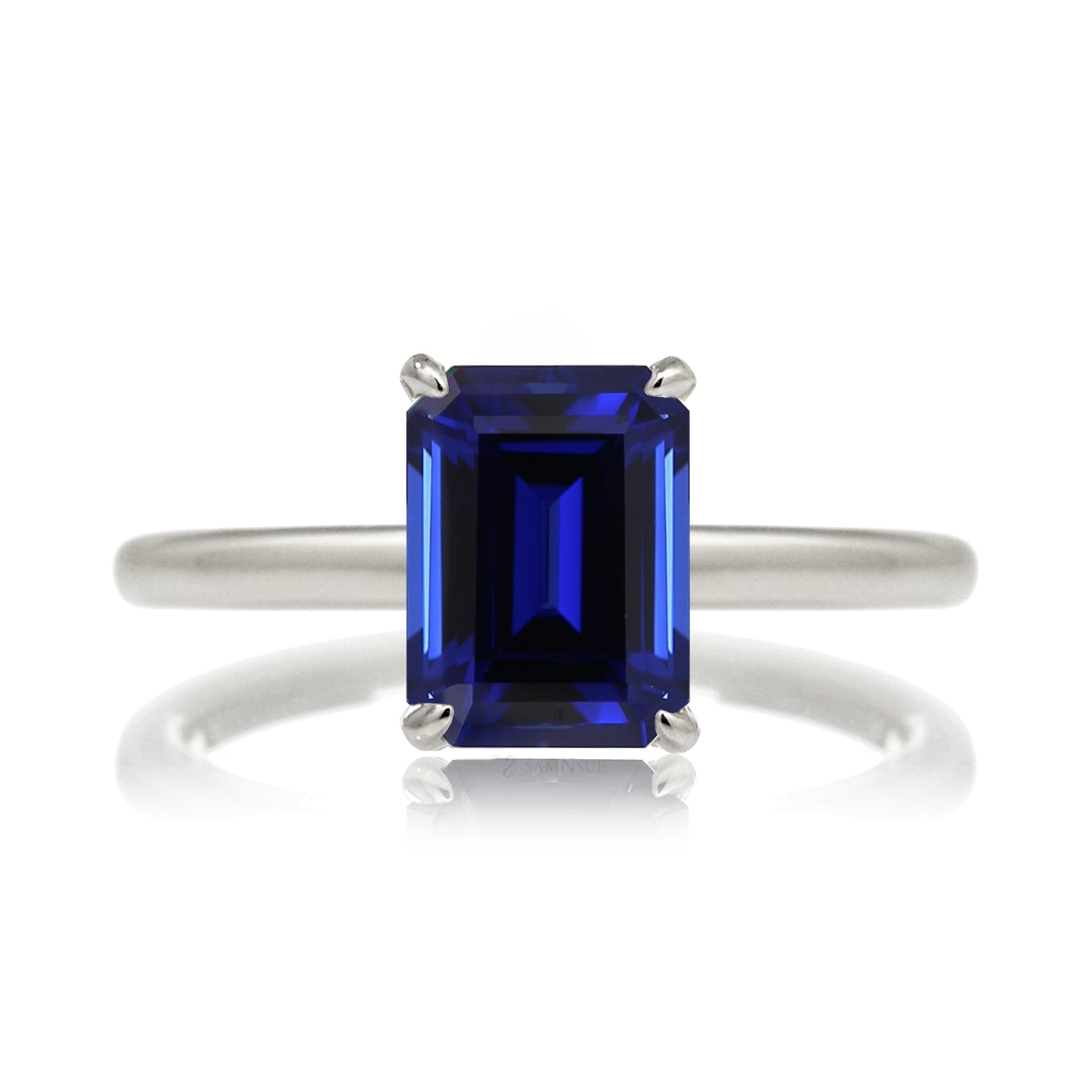 Emerald step cut blue sapphire engagement solitaire ring with hidden diamond halo in white gold