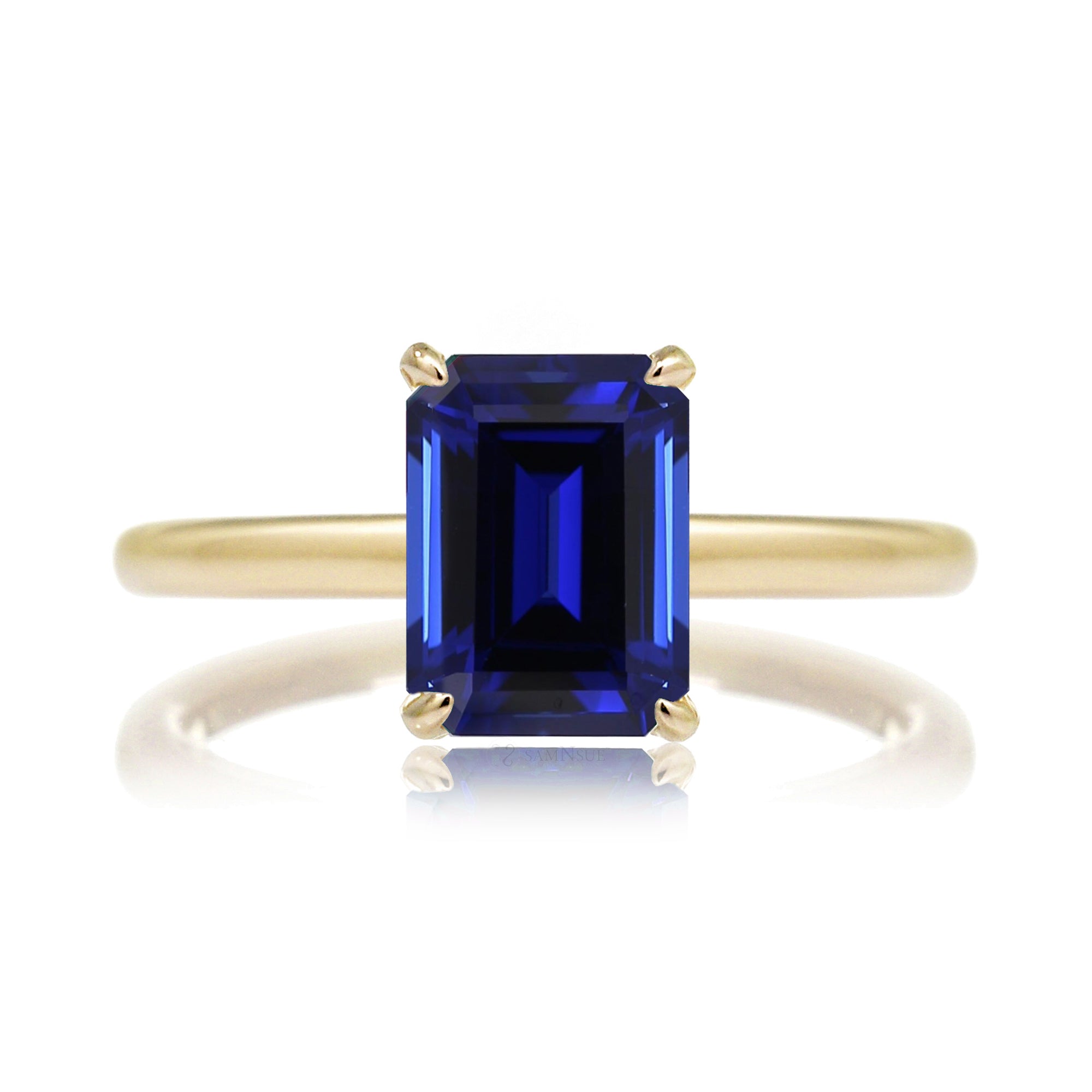 Emerald step cut blue sapphire engagement solitaire ring with hidden diamond halo in yellow gold