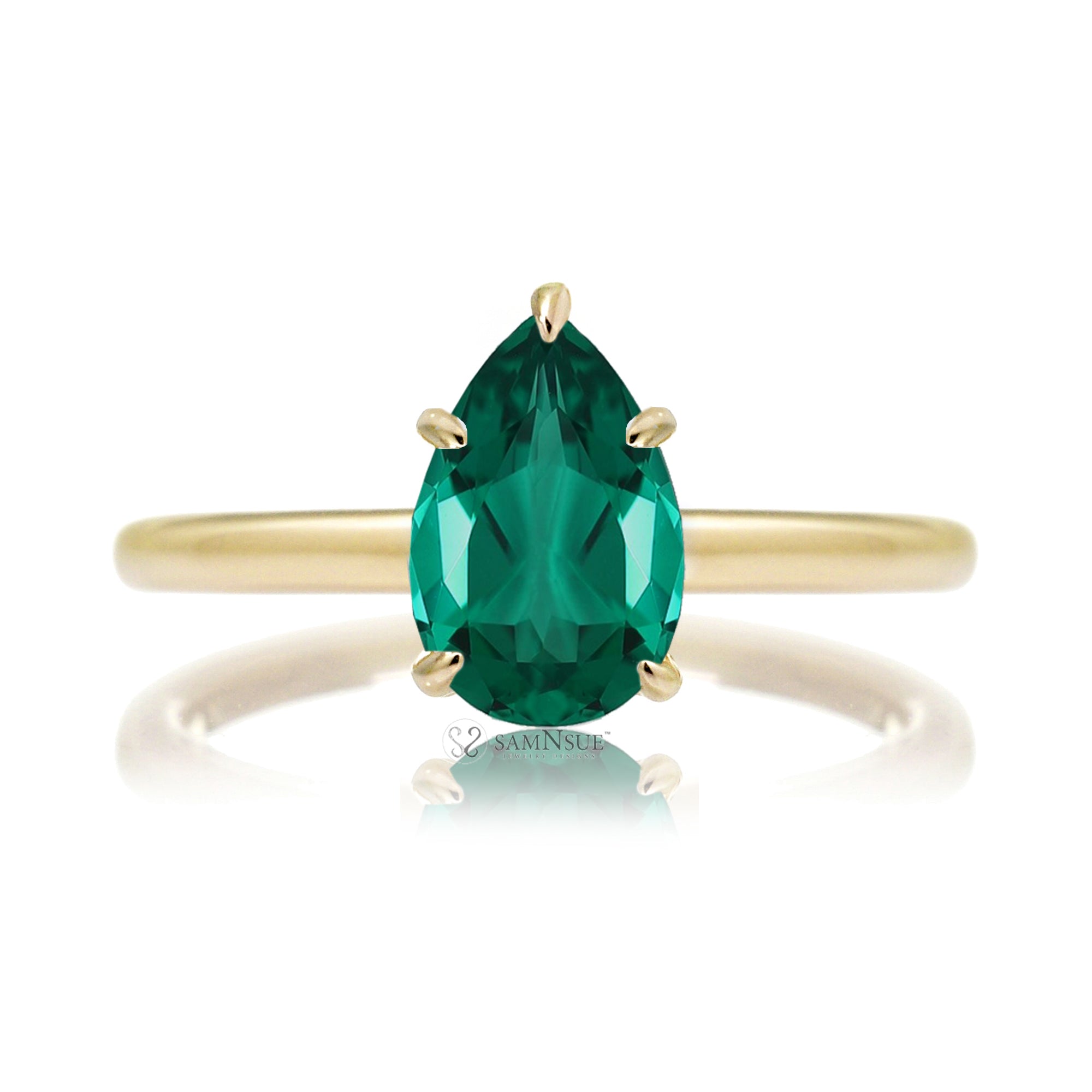 Pear cut green emerald ring with diamond hidden halo on yellow gold