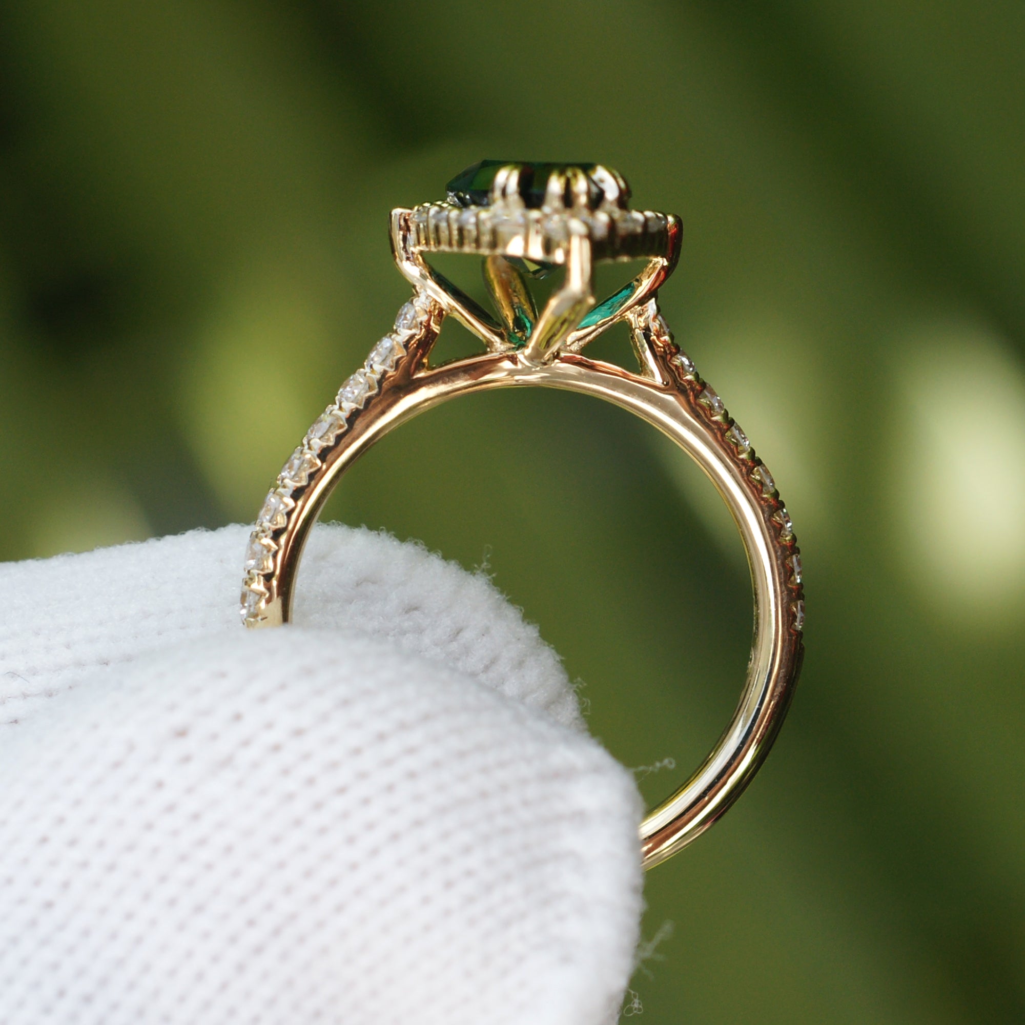Marquise emerald with diamond halo gradual diamond band yellow gold