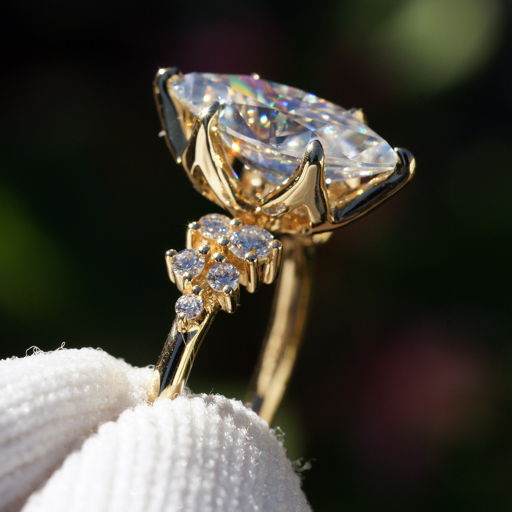 Marquise cut moissanite and diamond engagement ring in the stella yellow gold basket view