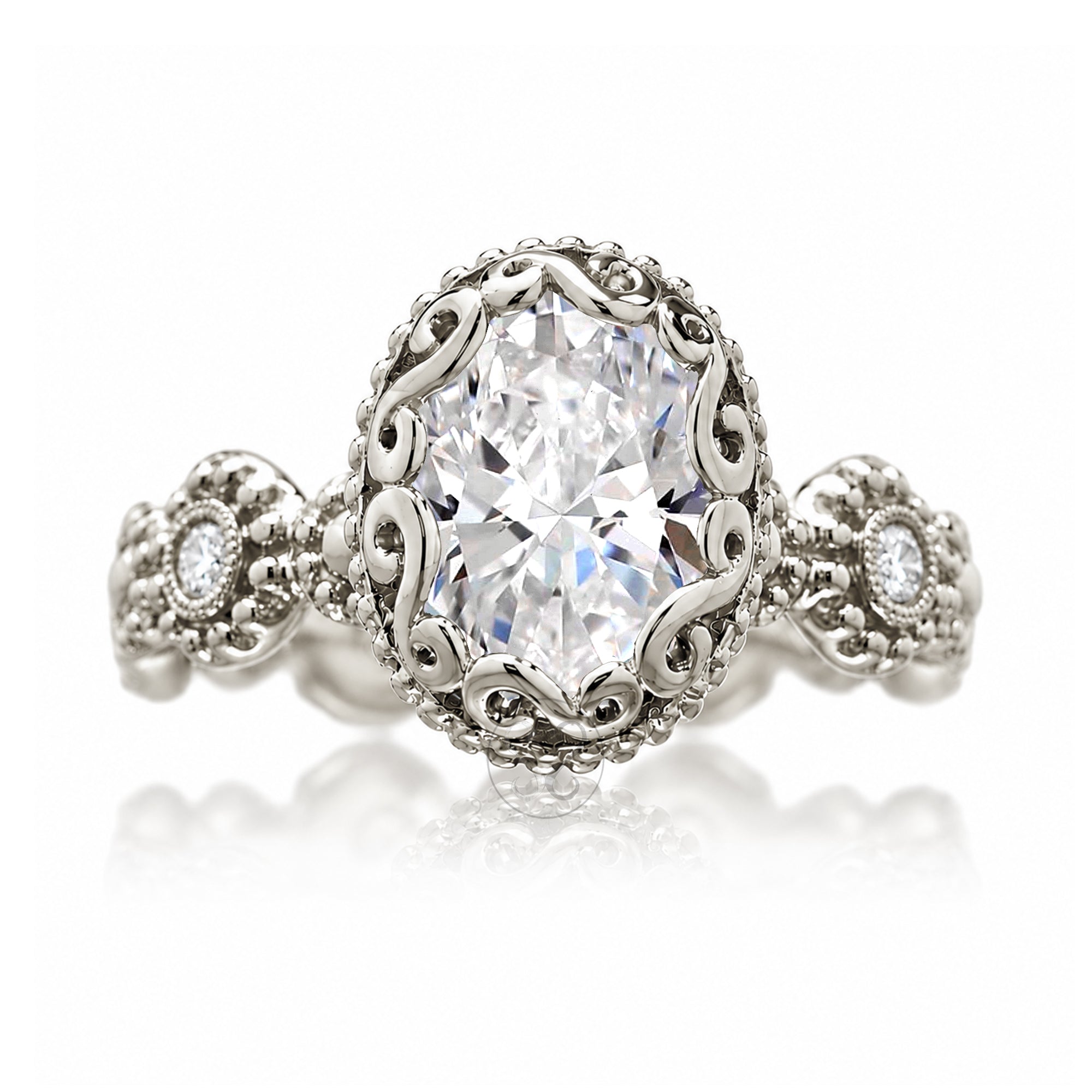 An ornate silver-tone ring featuring a large oval-cut clear center stone surrounded by a decorative filigree halo, with smaller accent stones on the band, shown on a white background with a soft reflection.