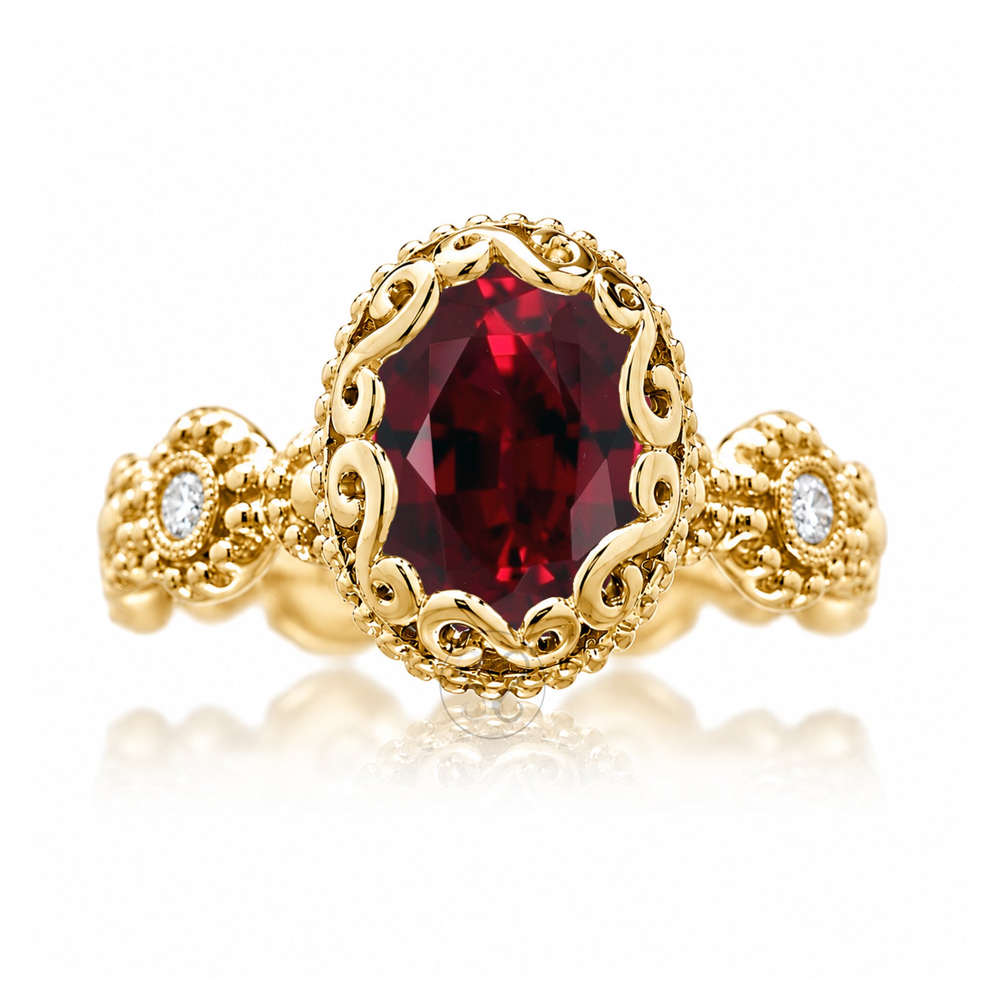 An ornate yellow gold ring featuring a large oval-cut deep red gemstone in a decorative filigree setting, with small round clear stones on the shoulders, shown on a white background with a soft reflection.