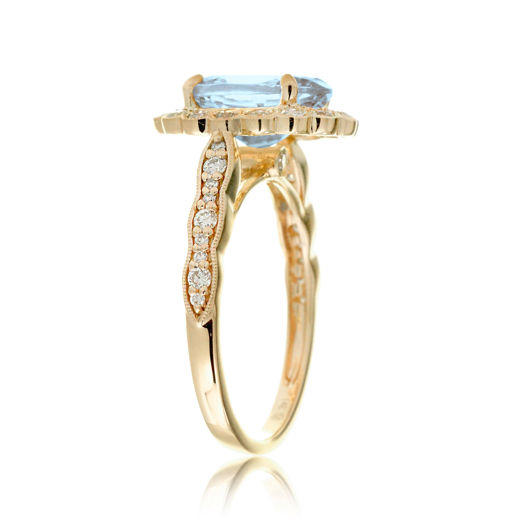 Oval aquamarine ring with diamond scallop halo and vintage diamond band in yellow gold
