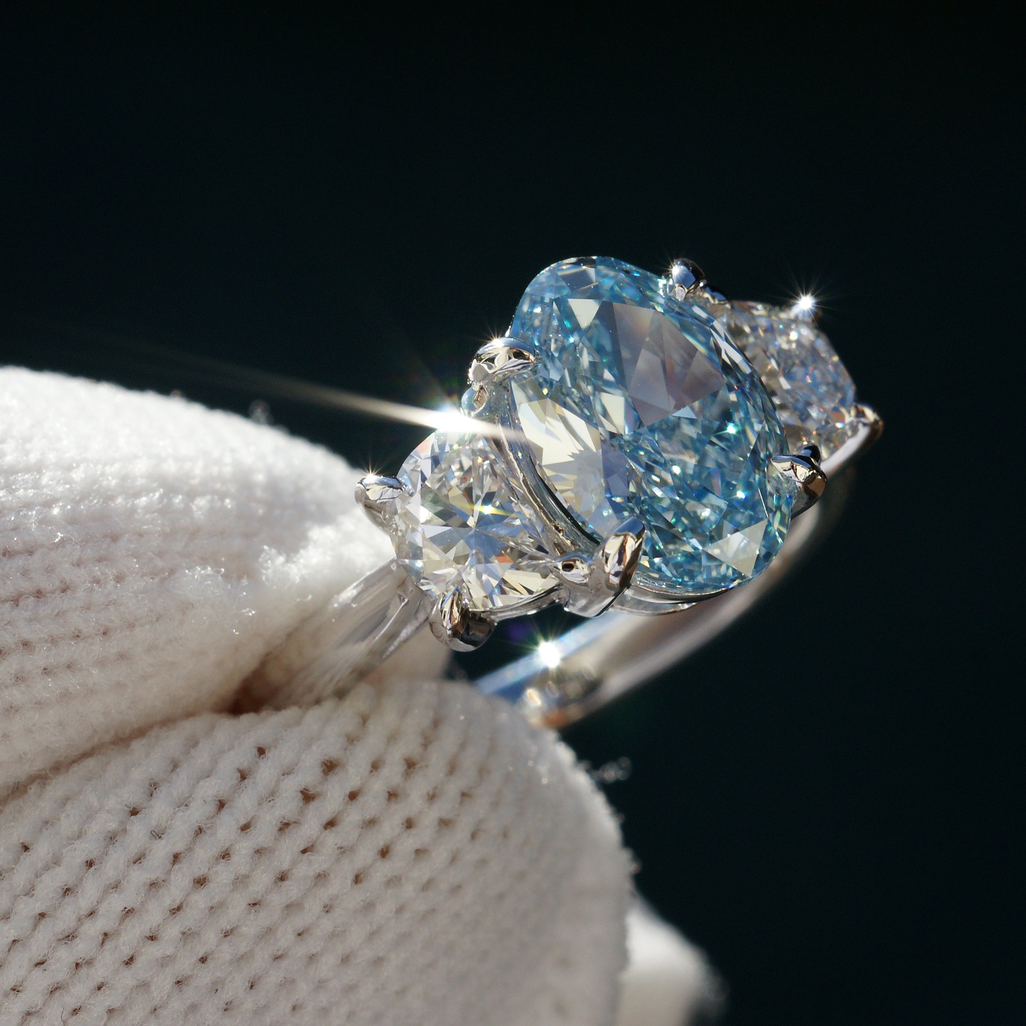 Oval blue diamond three stone half moon ring in platinum
