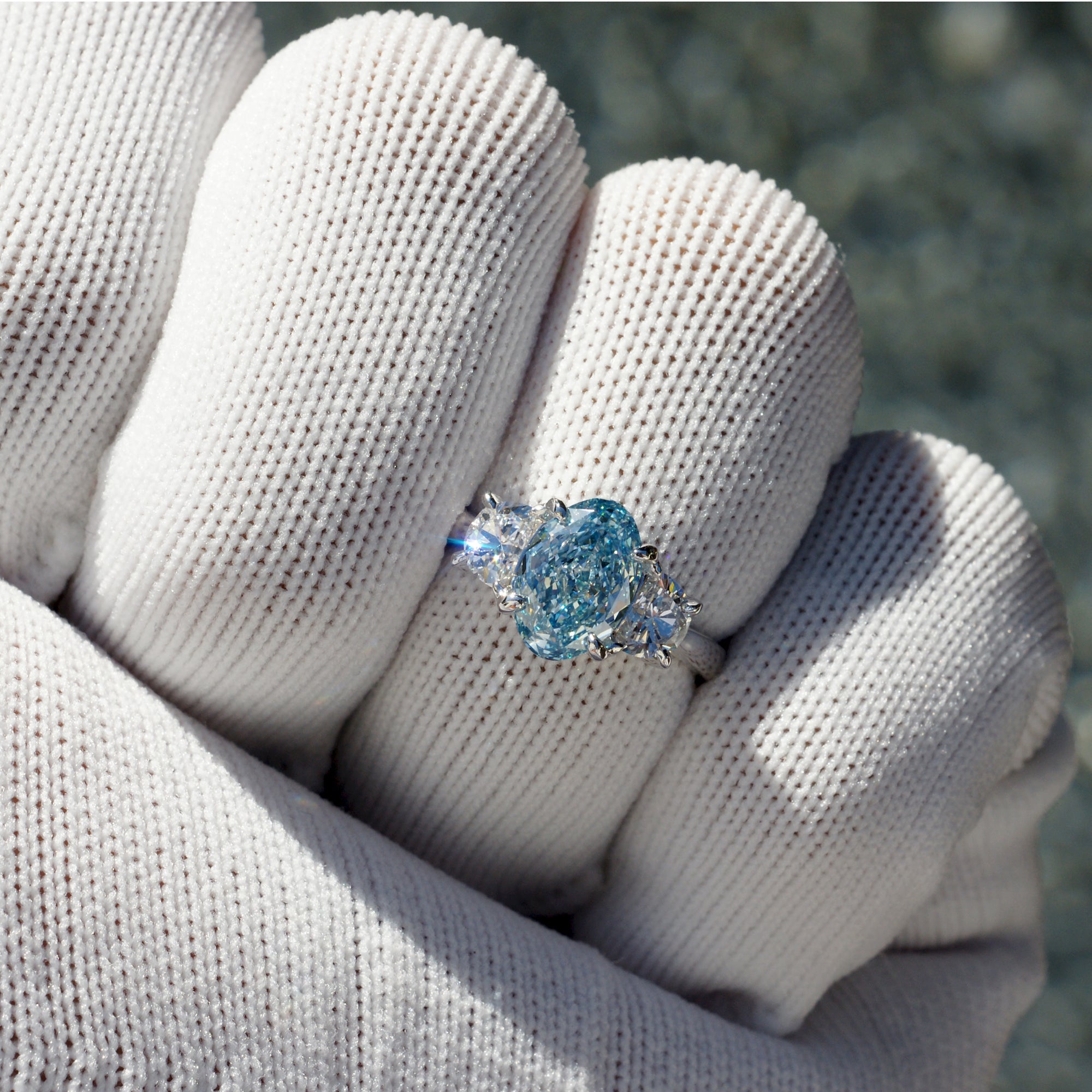 Oval blue diamond three stone half moon ring in platinum