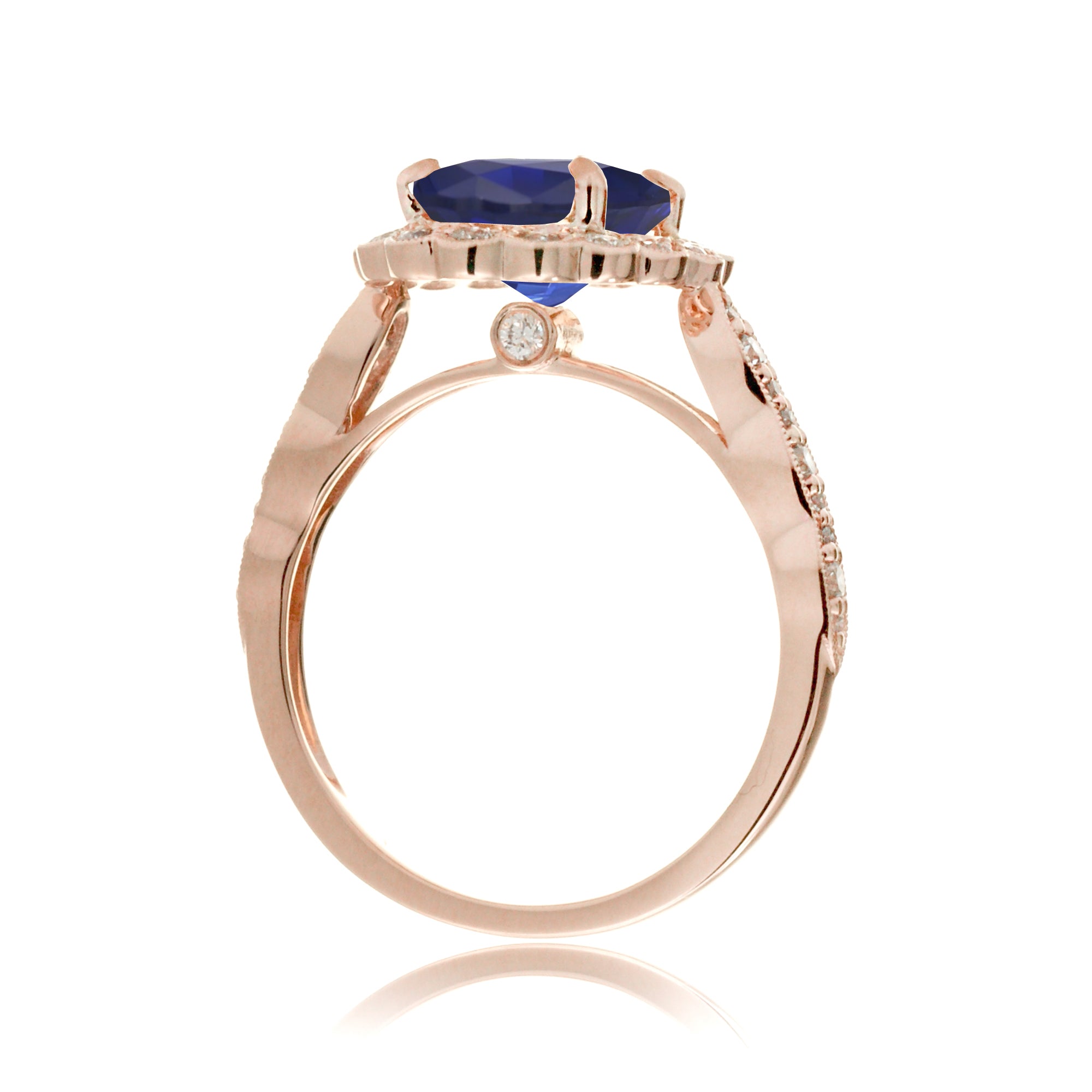 Blue oval sapphire ring with diamond halo in a vintage scallop design rose gold