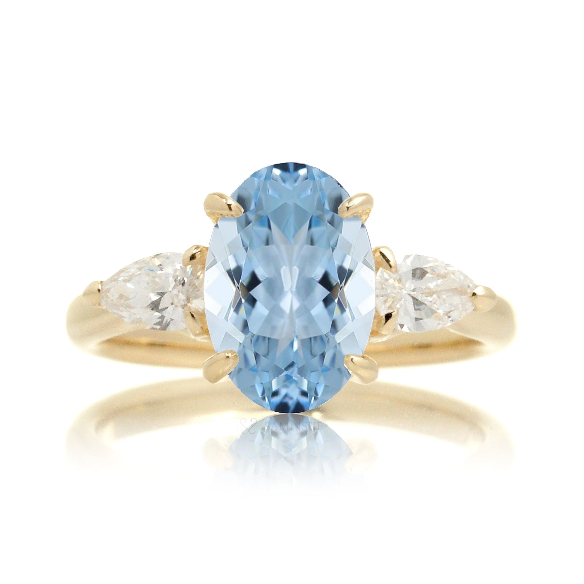Oval aquamarine proposal ring with pear side diamonds yellow gold