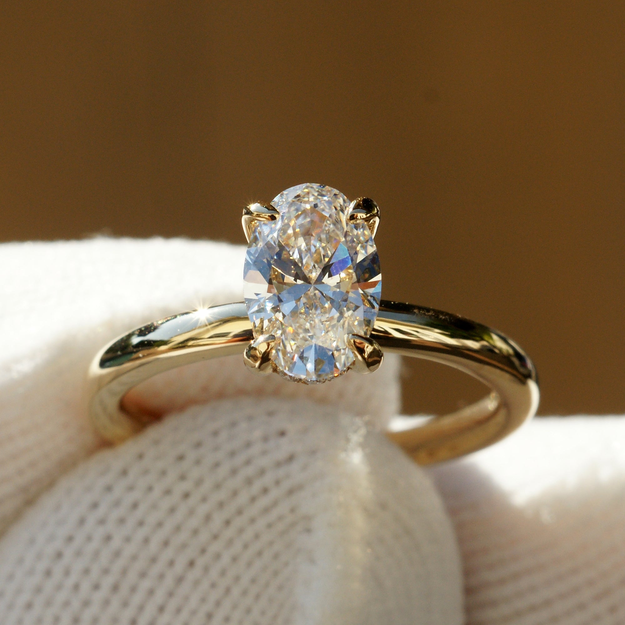 Front view of 1.04ct oval lab-grown diamond engagement ring in 18k yellow gold with high-polish solid band