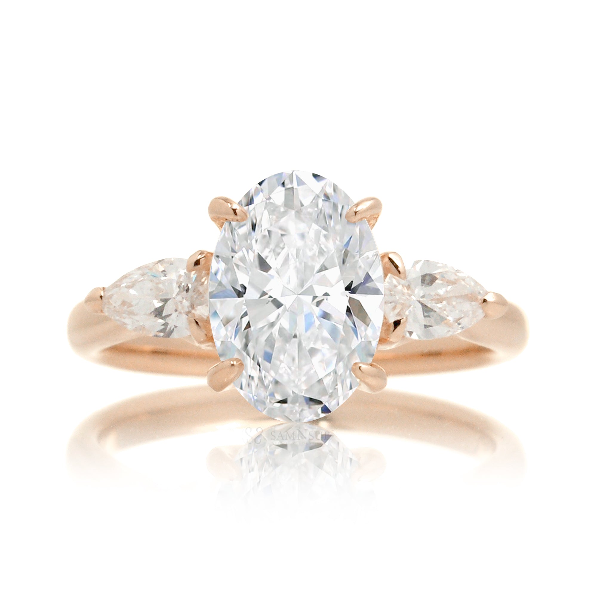 Three-stone pear and oval cut diamond engagement ring rose gold
